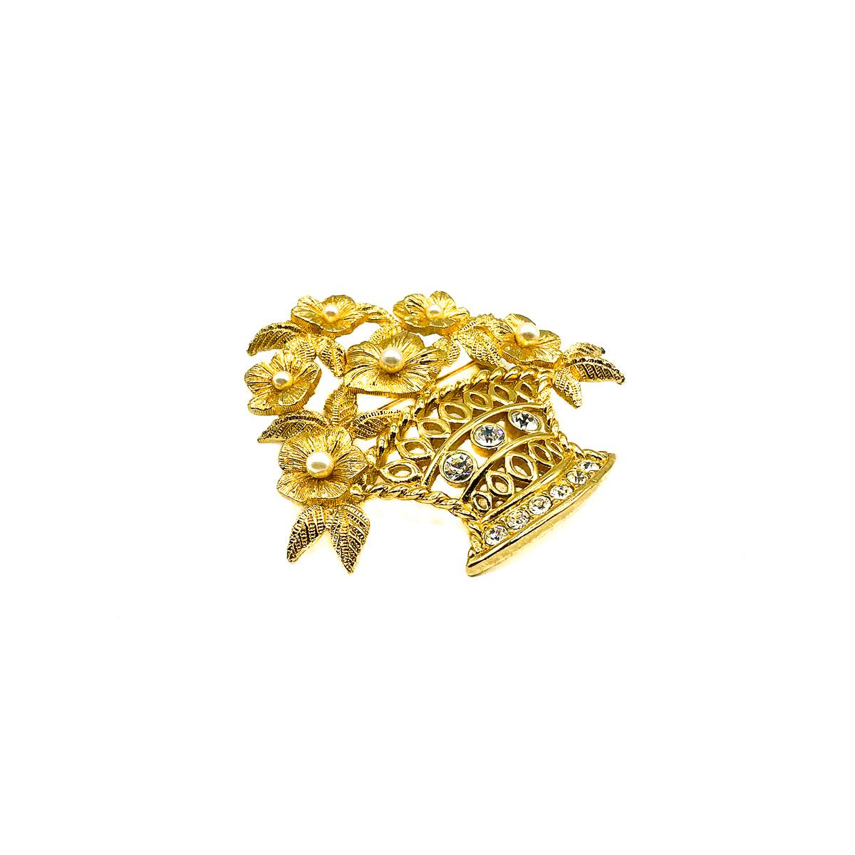 A Vintage Dior Flower Brooch. Crafted in gold plated metal and set with crystals and simulated pearls. In very good vintage condition. 6cms long. Signed. A beautiful statement brooch from the House of Dior that is so very classy and