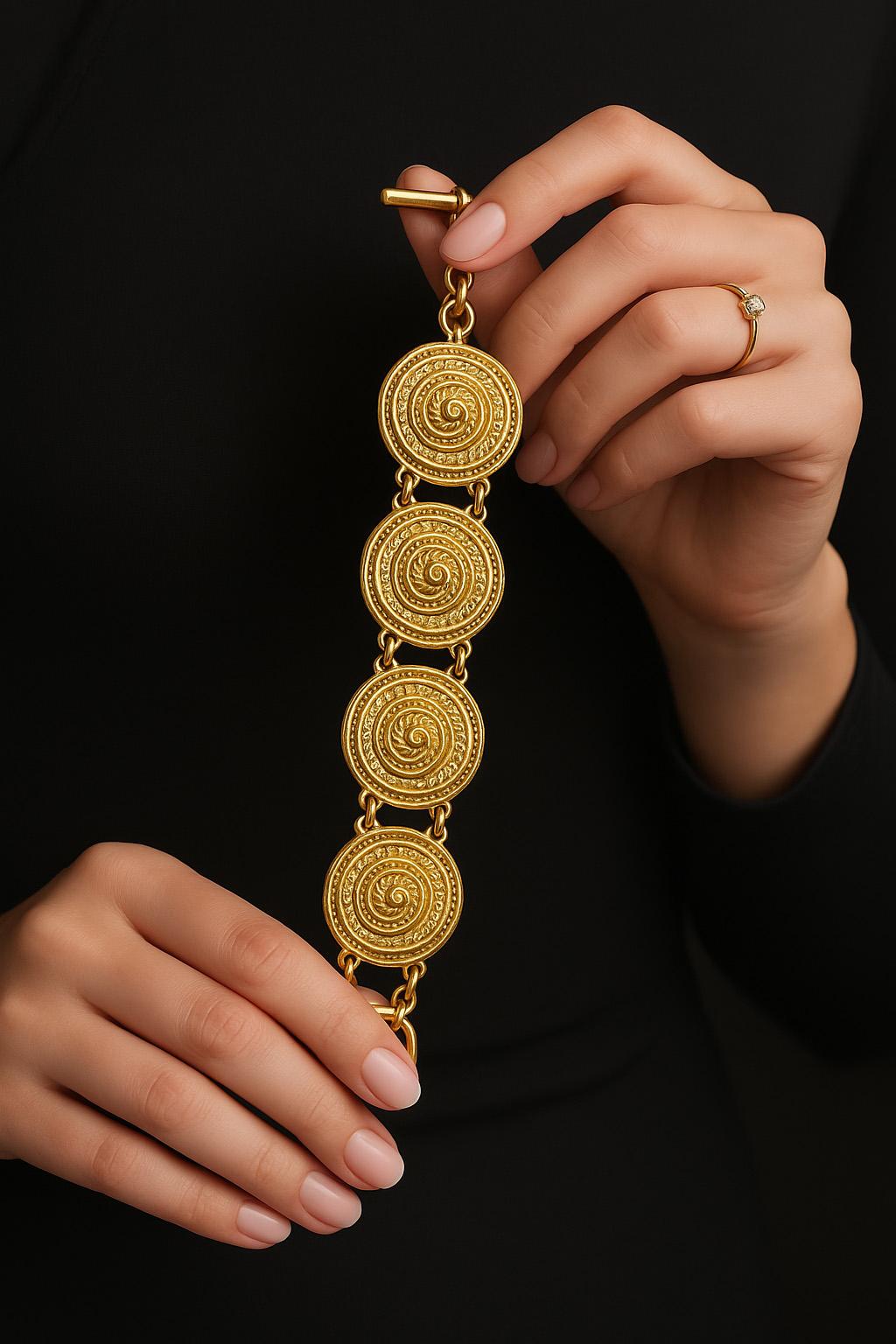A vintage Christian Dior bracelet, circa 1980s, crafted in gold-tone metal with bold circular textured links. The bracelet measures 18.2cm in length and 3cm in width, fastening with a T-bar clasp. A distinctive example of Dior vintage costume
