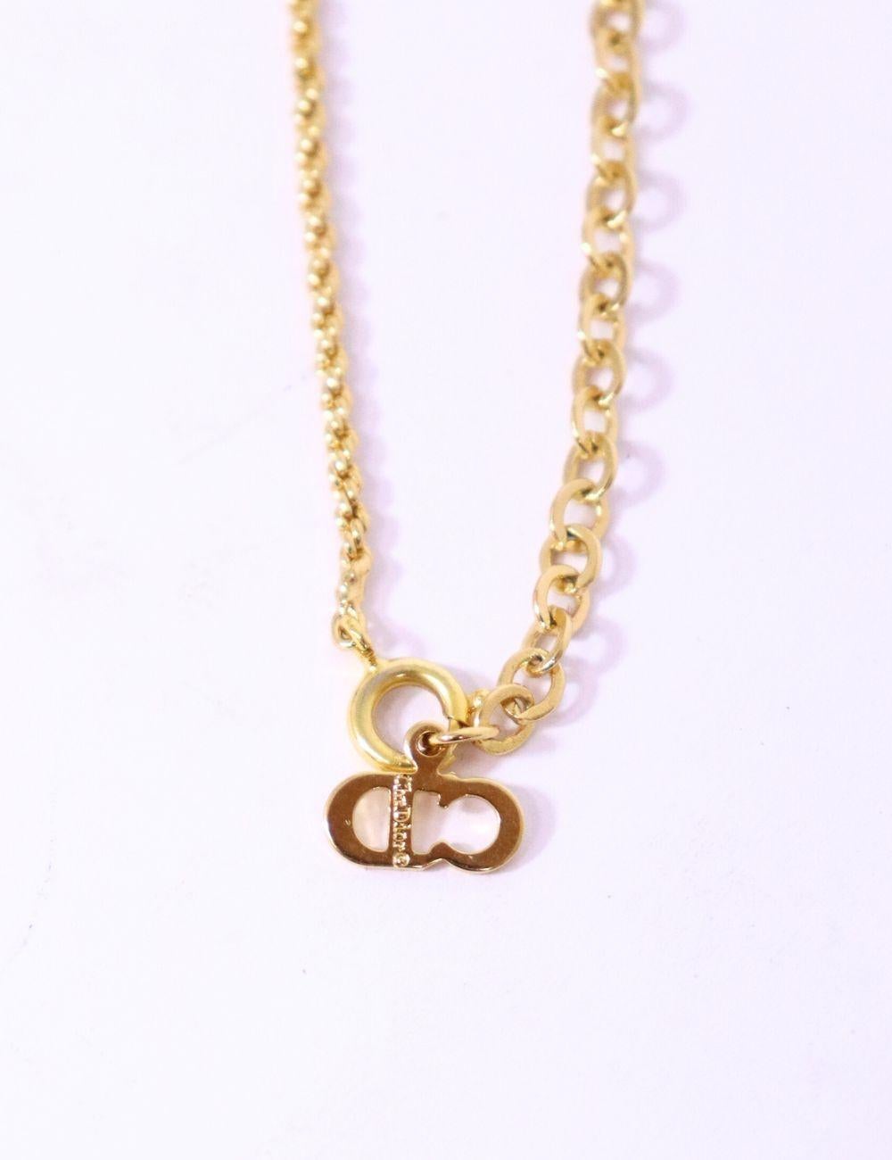 Embrace timeless Parisian elegance with this Christian Dior gold-tone logo medallion necklace. Featuring a delicate chain and a signature Dior 
