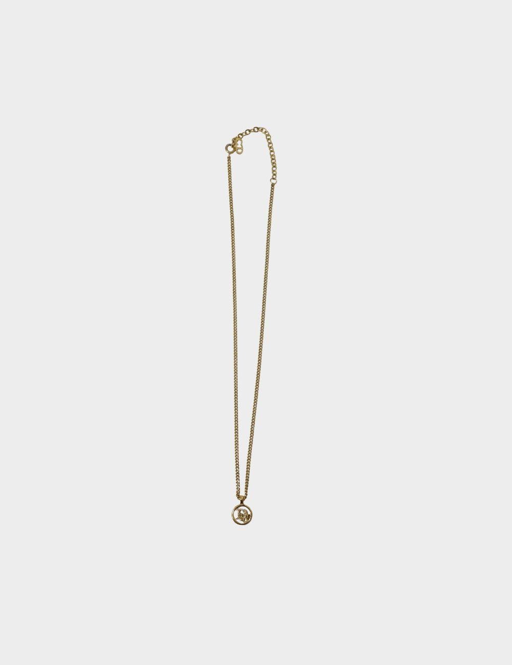 Add a touch of vintage elegance to your jewelry collection with this Christian Dior gold-tone logo pendant necklace. Featuring the iconic Dior 