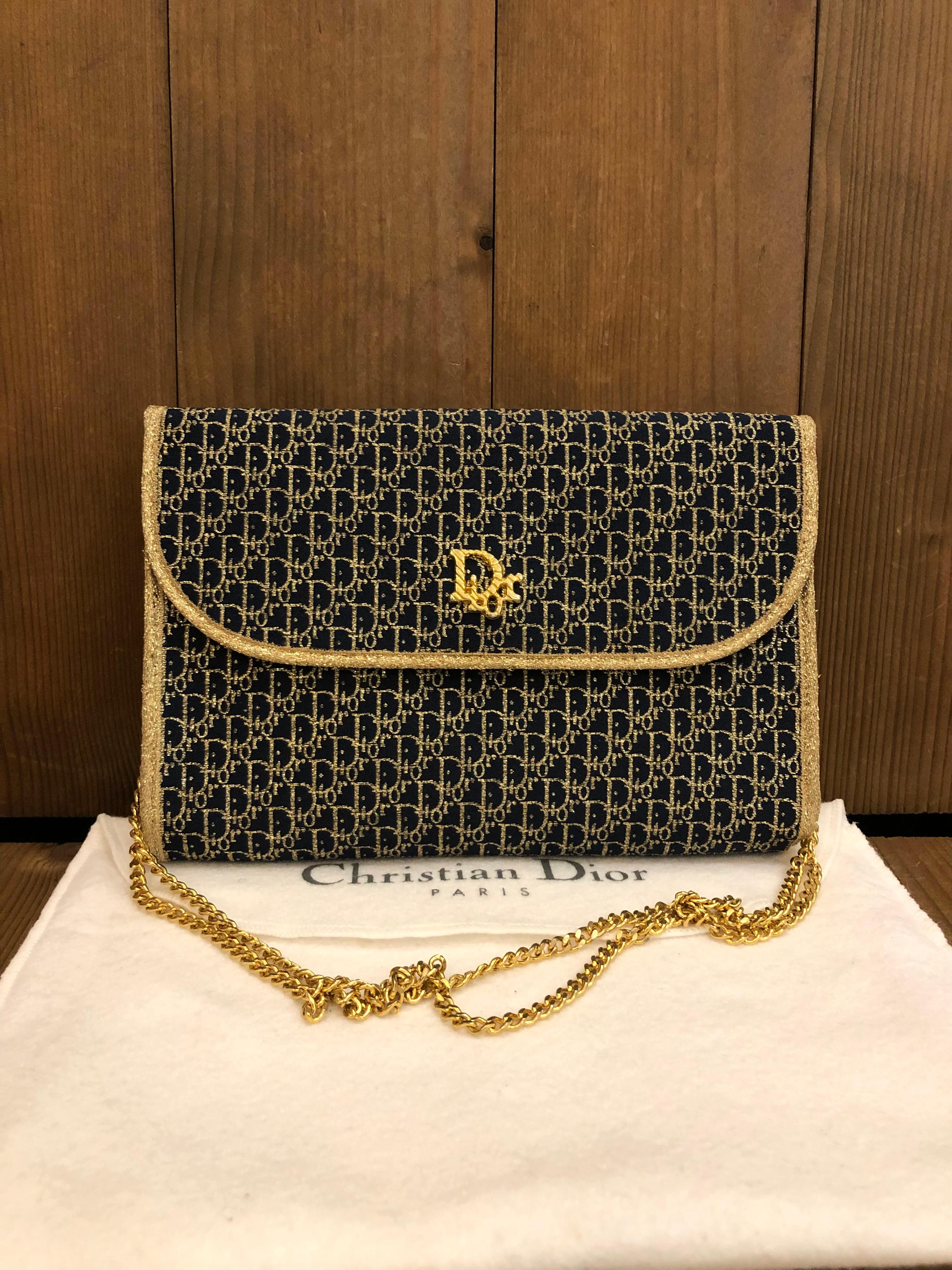 This vintage Christian Dior chain bag is crafted of Dior's signature trotter jacquard in gold and navy. Front flap closure with snap fastening opens to a navy leather interior. This vintage Dior features a gold toned chain that allows you to carry