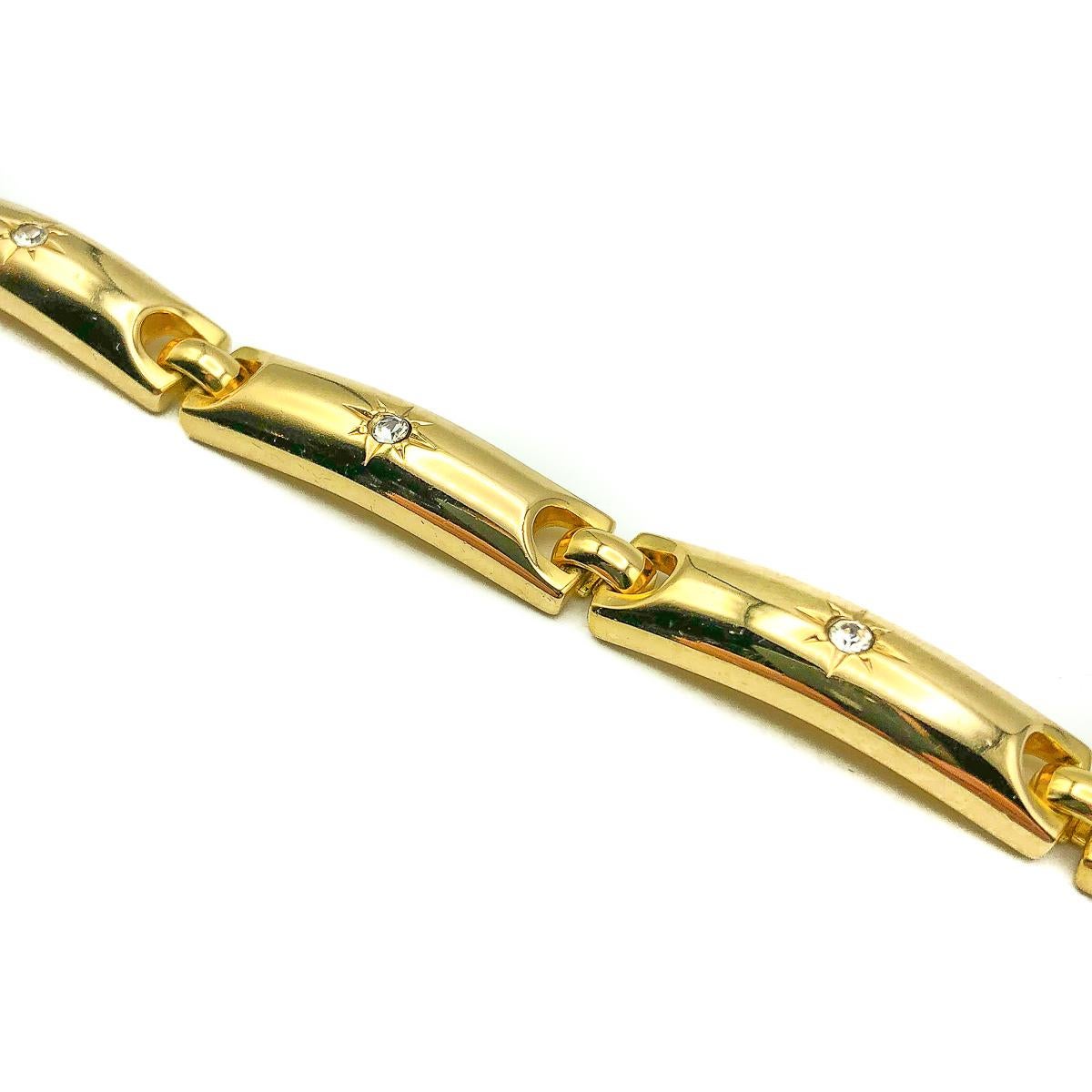 A divine Vintage Dior Gold Stars Bracelet. Weighty and beautifully made. Crafted in gold plated metal with each of the five sections finished with a crystal in a star motif. The star symbolising Christian Dior's lucky talisman to which he believed