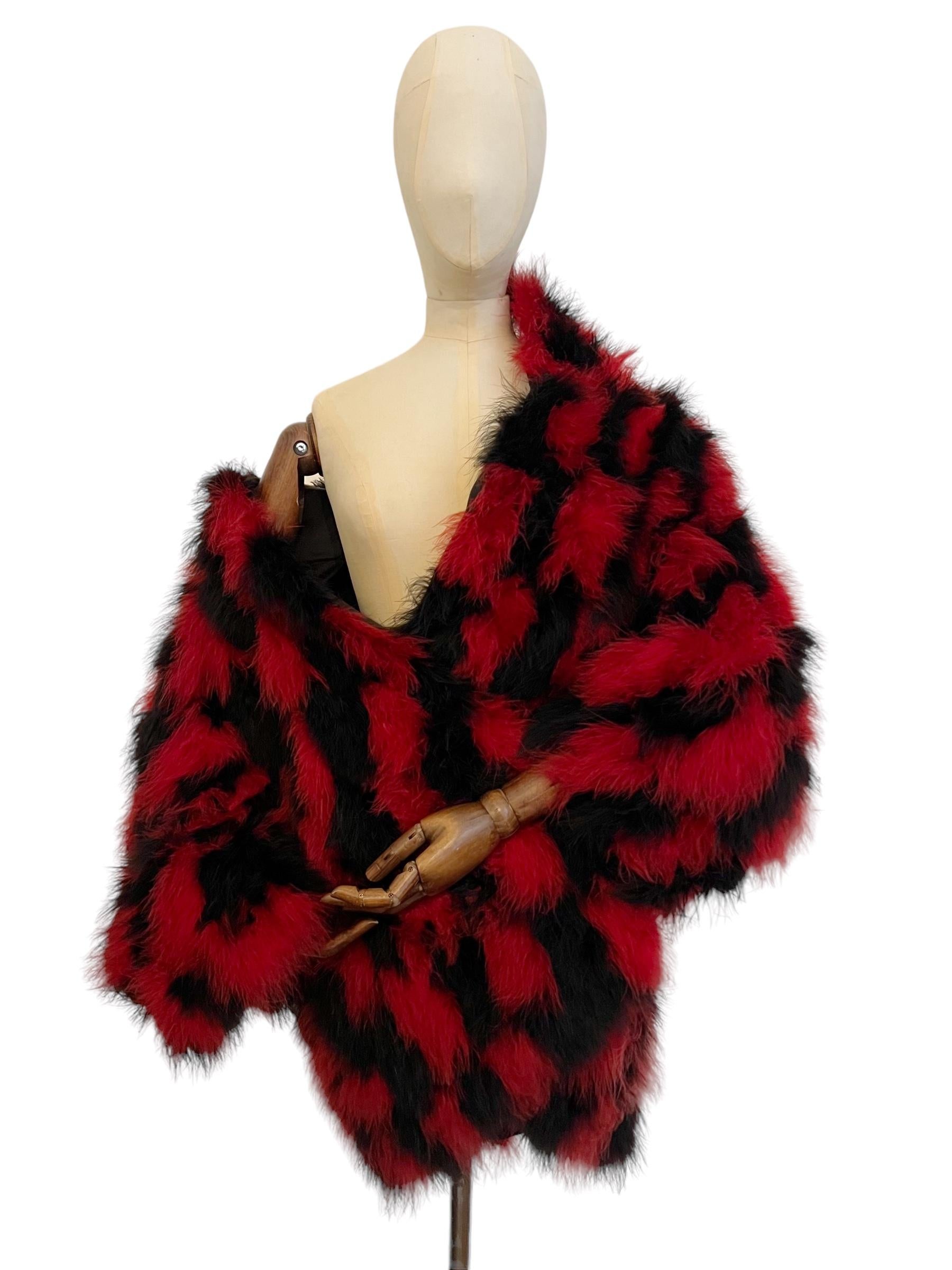 Decadent Vintage Christian Dior Jacket circa 1970.

An Elegant Red and Black Check board pattern, Oversized Marabou feather Jacket.

Featuring long sleeves, full black interior lining, outer hip pockets and single central line farrier hook fasten