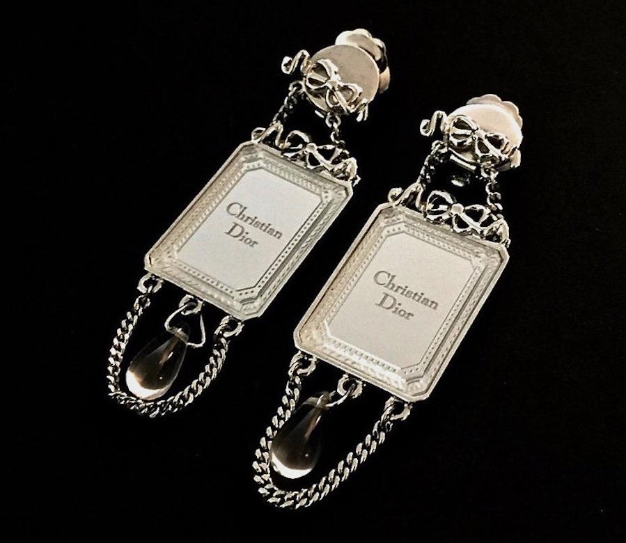 Vintage CHRISTIAN DIOR Iconic French Bow Mirror Drop Earrings

Measurements:
Height: 2 5/8 inches (6.66 cm)
Width: 6/8 inch (1.90 cm)

Features:
- 100% Authentic CHRISTIAN DIOR.
- Dior iconic bow frame mirror.
- Inscribed CHRISTIAN DIOR at the