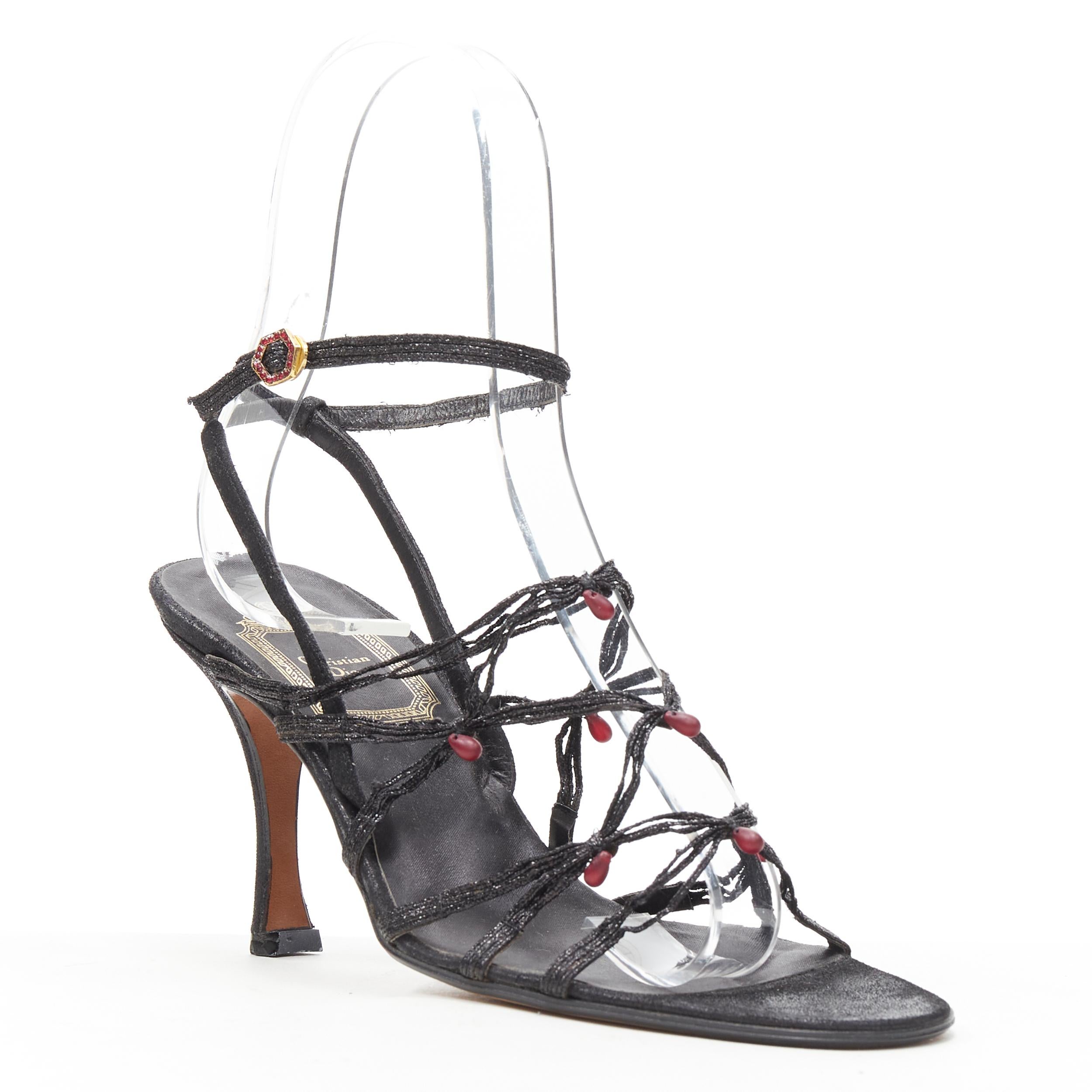 vintage CHRISTIAN DIOR John Galliano black strappy red bead sandal EU36.5 
Reference: GIYG/A00108 
Brand: Christian Dior 
Designer: John Galliano 
Model: Bead woven sandals 
Material: Leather 
Color: Black 
Pattern: Solid 
Closure: Ankle Strap