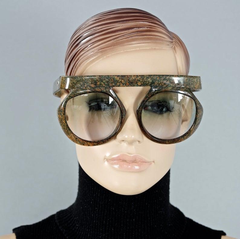 Vintage CHRISTIAN DIOR Lady Gaga Oversized Space Age Sunglasses

Measurements:
Vertical Height: 3.18 inches (8.1 cm)
Horizontal Width: 5.9 inches  (15 cm)
Temple Length: 5.23 inches  (13.3 cm)

As seen on Lady Gaga.

Features:
- 100% Authentic