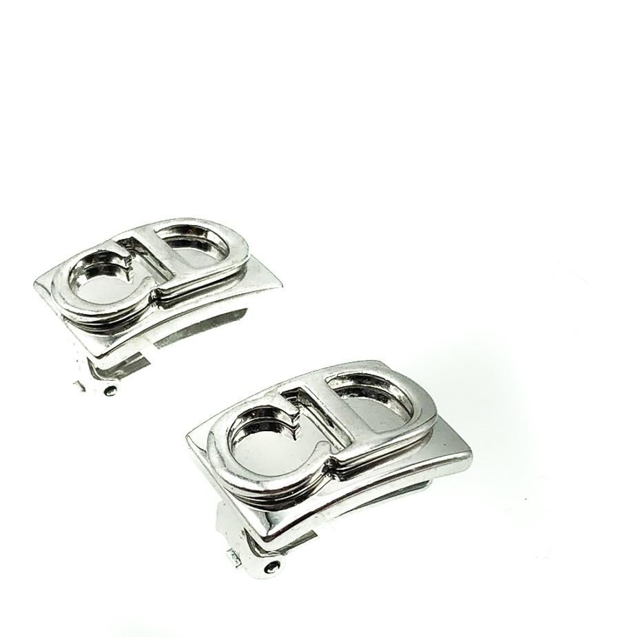 An iconic pair of Vintage Dior CD Logo Earrings. Crafted in silver-tone metal. Featuring an curved platform decorated with the iconic initials of the House of Dior. In very good vintage condition without damage or repair, signed, approx. 2.4cms.