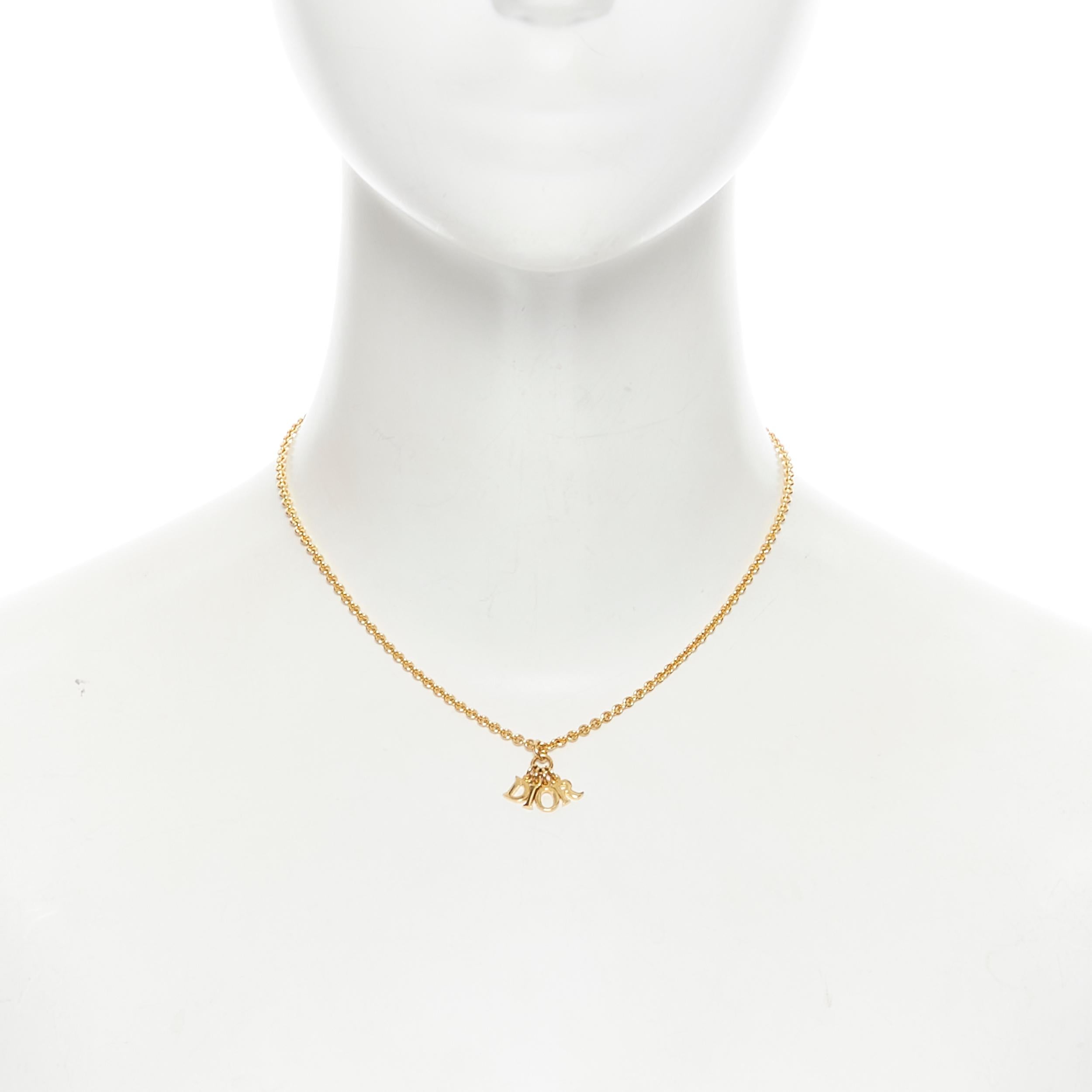 vintage CHRISTIAN DIOR logo dangle charm gold chain short necklace 
Reference: TGAS/B00714 
Brand: Christian Dior 
Designer: John Galliano 
Material: Metal 
Color: Gold 
Pattern: Solid 
Closure: Clasp 

CONDITION: 
Condition: Very good, this item