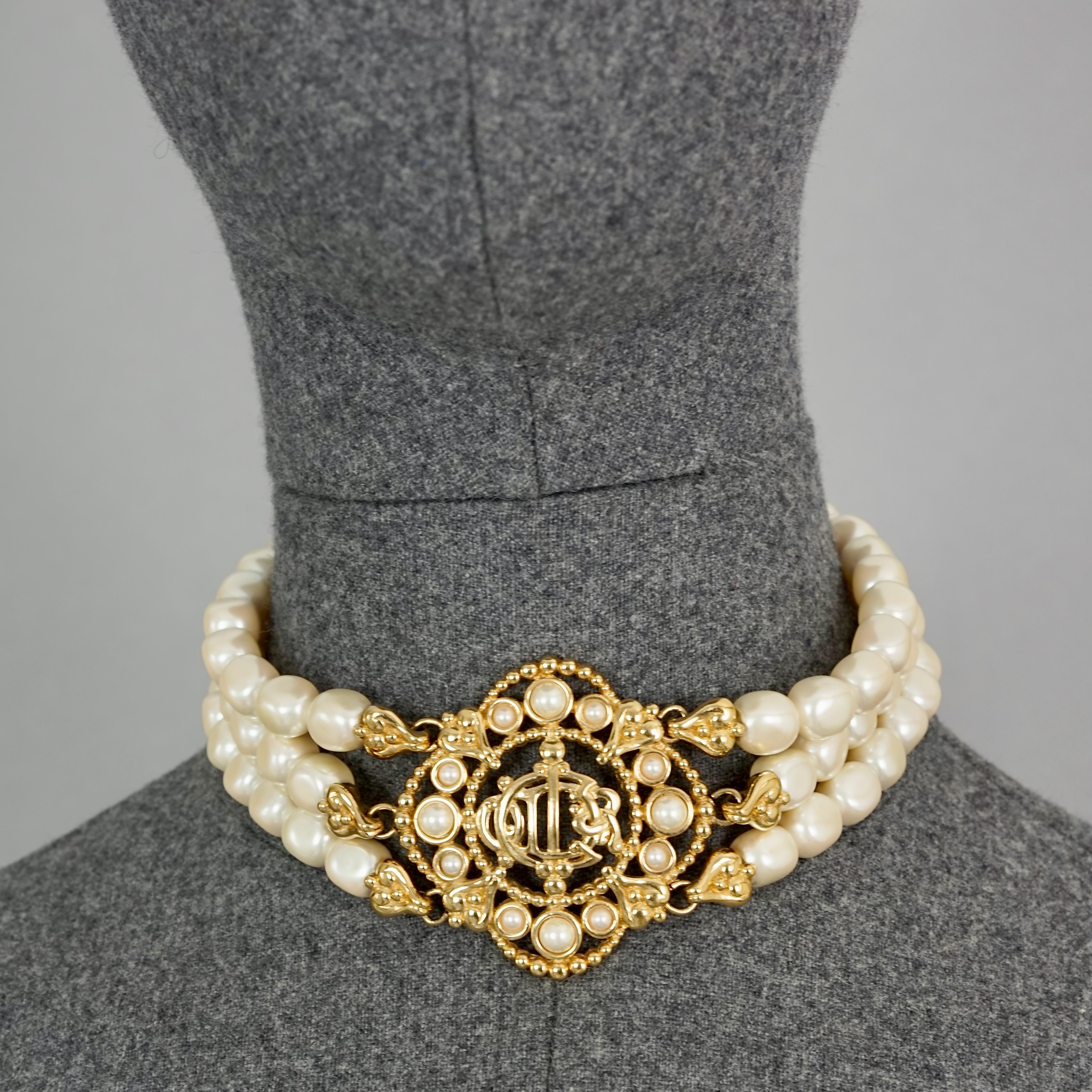 Vintage CHRISTIAN DIOR Logo Insignia Medallion Tiered Pearl Choker Necklace

MEASUREMENTS:
Height: 2.16 inches (5.5 cm)
Wearable Length: 13.38 inches to 15.15 inches (34 cm to 38.5 cm)

FEATURES:
- 100% Authentic CHRISTIAN DIOR.
- 3 Tiered glass