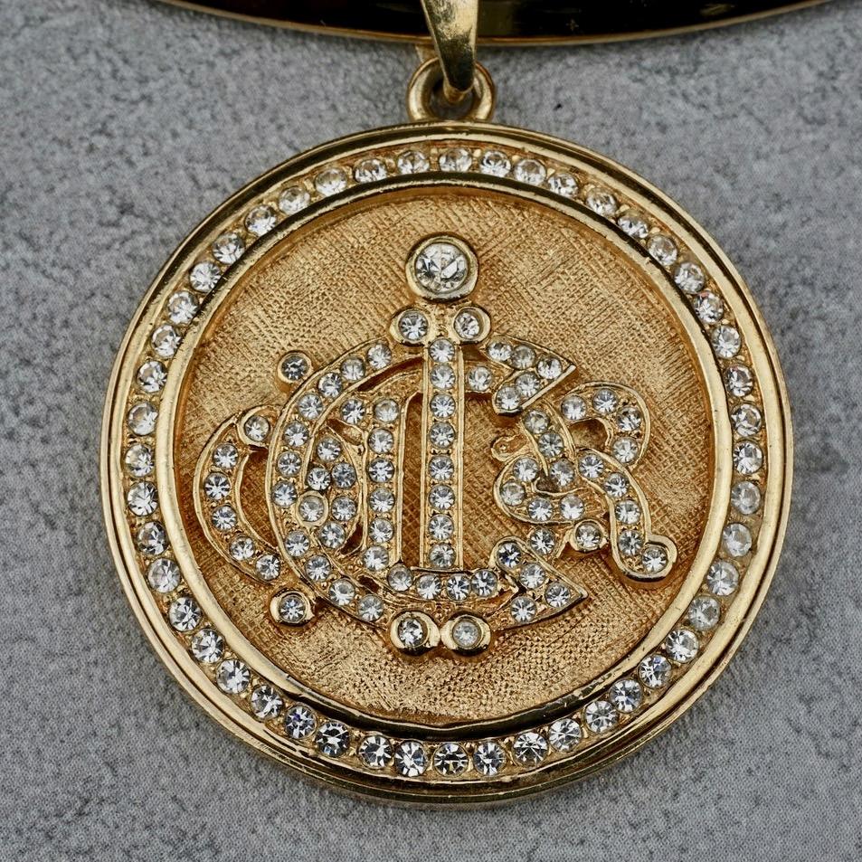 Vintage CHRISTIAN DIOR Logo Insignia Rhinestone Pendant

Measurements:
Medallion Height: 1.5 inches (3.8cm)
Medallion Width: 1.5 inches (3.8cm)

Features:
- 100% Authentic CHRISTIAN DIOR.
- Round pendant with DIOR insignia/ logo rhinestones
