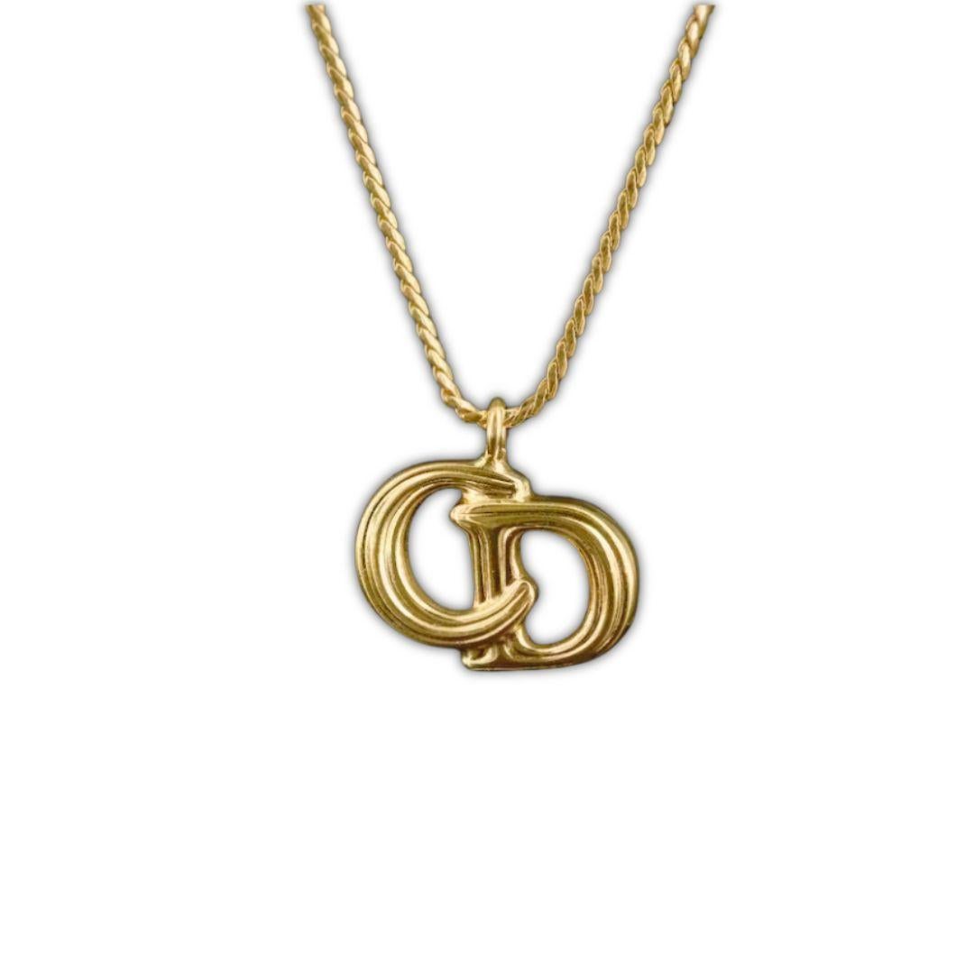 Indulge in luxury with our Vintage Christian Dior Logo Necklace. Crafted with intricate detail and adorned with the renowned Dior logo, this necklace exudes sophistication and elegance. Elevate your style and make a statement with this timeless