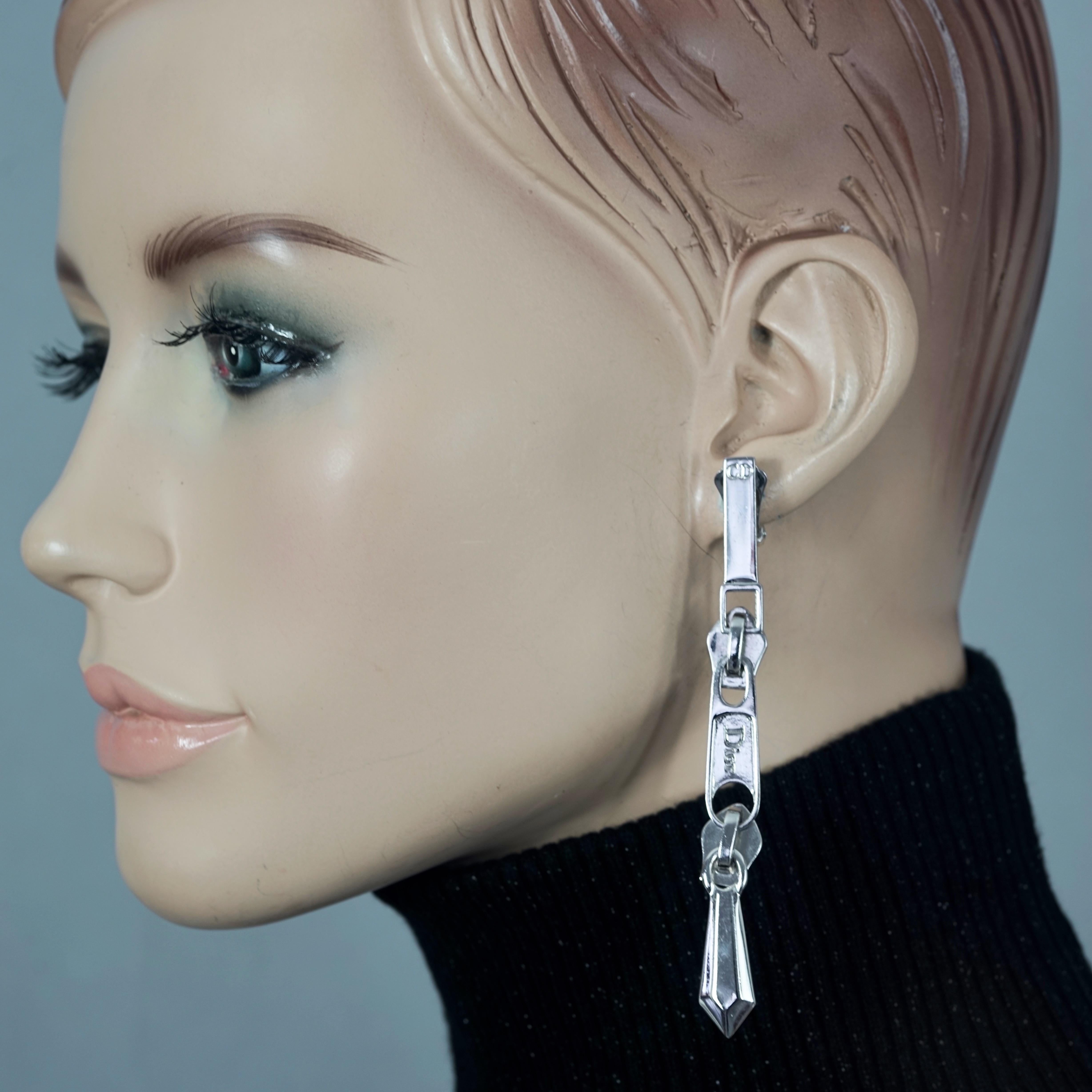 Vintage CHRISTIAN DIOR Logo Zipper Pull Dangling Earrings

Measurements:
Height: 3.62 inches (9.2 cm)
Width: 0.39 inch (1 cm)
Weight per Earring: 10 grams

Features:
- 100% Authentic CHRISTIAN DIOR.
- Novelty zipper pull dangling earrings with