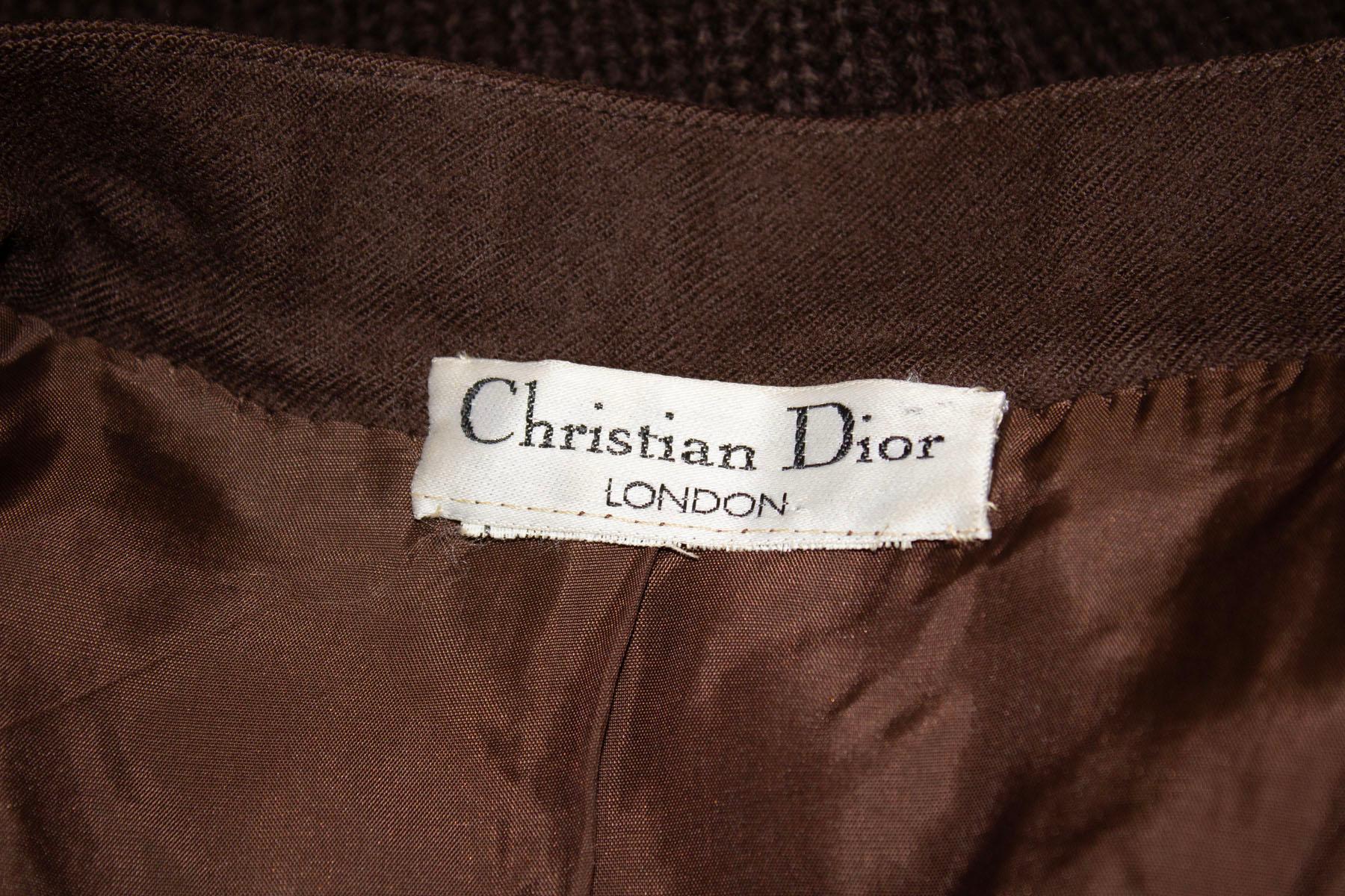 A great skirt and jacket combination from Christian Dior , London. The jacket has a button front opening, with knitted front, back and cuffs. The remainder of the jacket is wool. The skirt is in wool, fully lined with two pockets. 
Measurements: