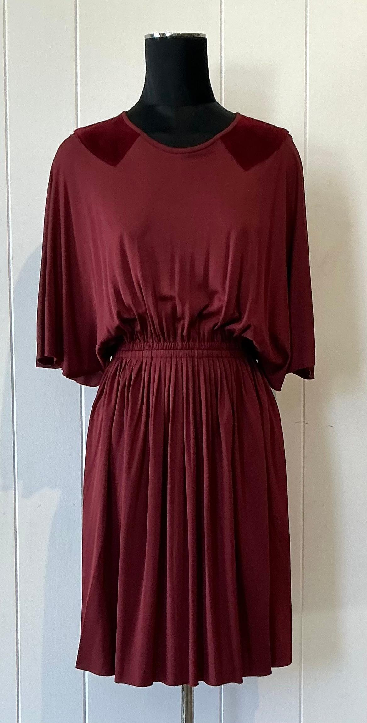 Embrace the timeless elegance of vintage couture with this stunning Christian Dior flutter dress, a true embodiment of feminine grace and refined design. Crafted in luxurious fabric, the dress features a delicately pleated skirt that adds soft