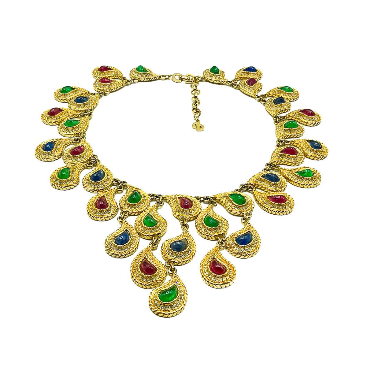 What a find. The most sublime and richly jewelled Vintage Christian Dior Mughal Bib Necklace. Crafted in high quality gold plated metal and set with exquisite glass paisley stones, depicting flawed rubies, sapphires and emeralds and surrounded by