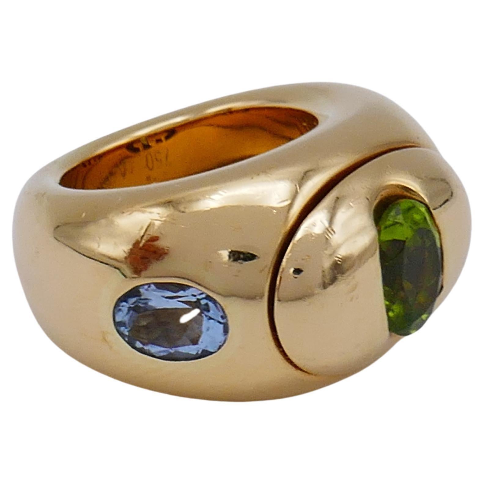 An amazing multi gemstone 18k gold band ring by Christian Dior. Features peridot, blue topaz and pink tourmaline. Has pierced 