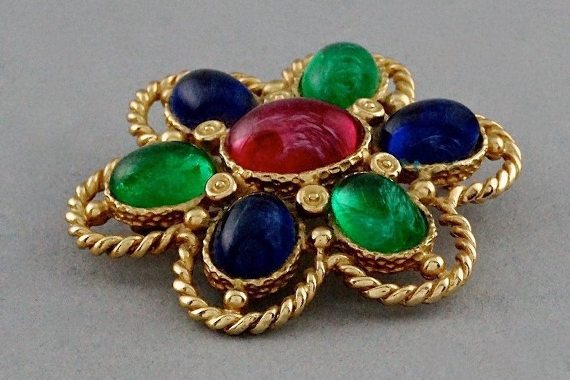 Vintage CHRISTIAN DIOR Multicolour Glass Cabochon Gripoix Flower Brooch

Measurements:
Height: 2.28 inches (5.8 cm)
Width: 2.40 inches (6.1 cm)

Features:
- 100% Authentic CHRISTIAN DIOR.
- Flower brooch embellished with green, blue and red glass