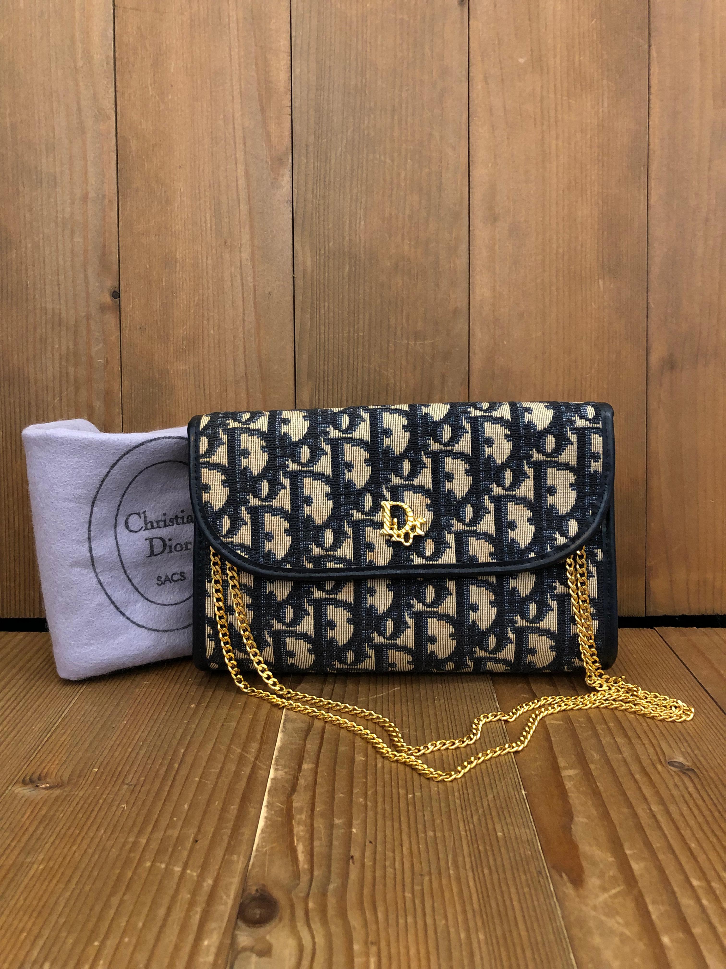 This beautiful vintage Christian Dior chain bag is crafted of Dior's signature trotter jacquard in navy. Front flap closure with snap fastening opens to a coated interior in navy. This vintage Dior features a gold toned chain that lets you carry it