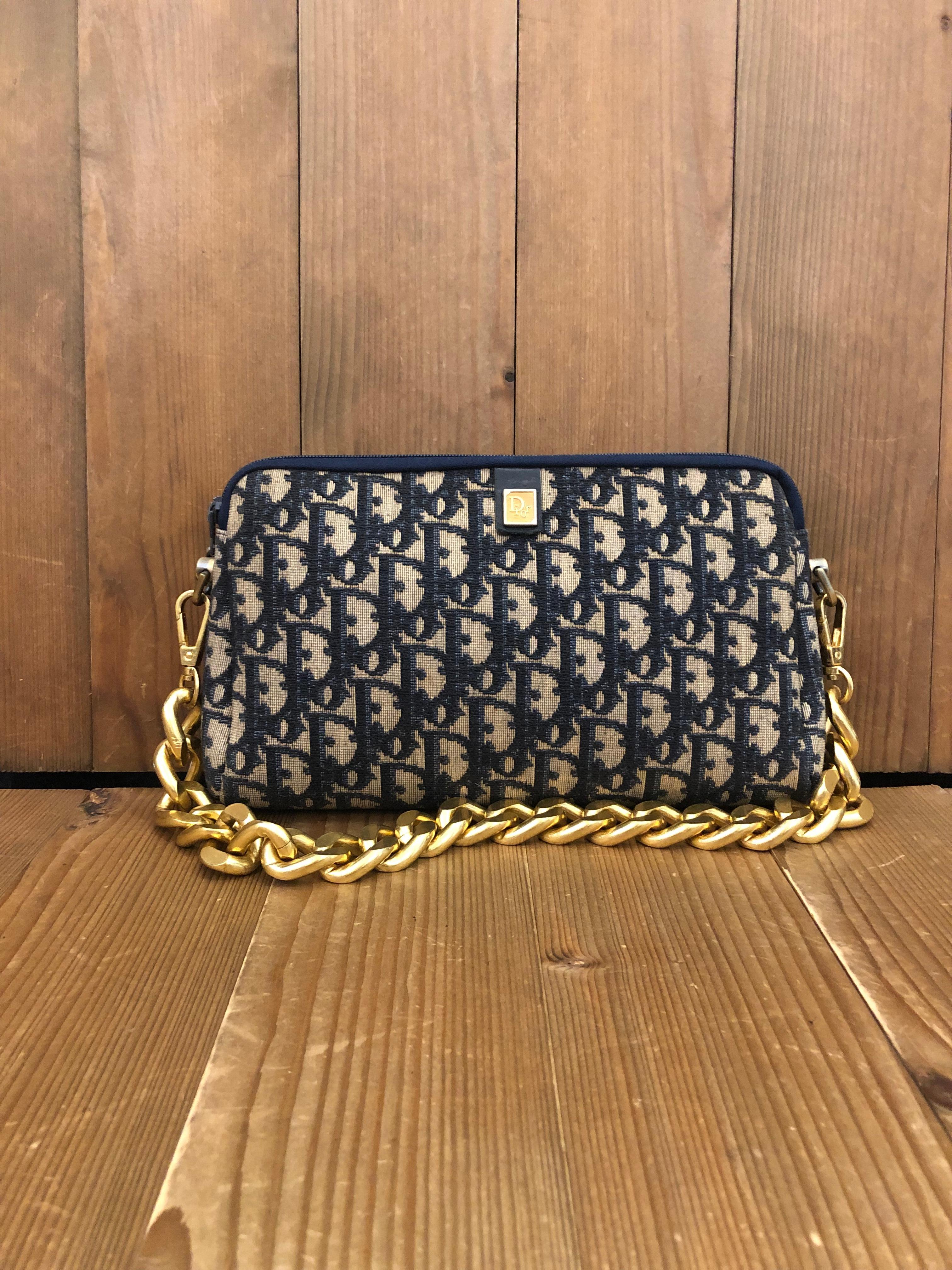 Vintage CHRISTIAN DIOR Clutch bag in navy Trotter jacquard with leather interior. Medium in size which fits plus-sized cell phone and other small accessories. Made in France. Measures approximately 9.5 x 6 x 1.75 inches. Third party non-Dior parts