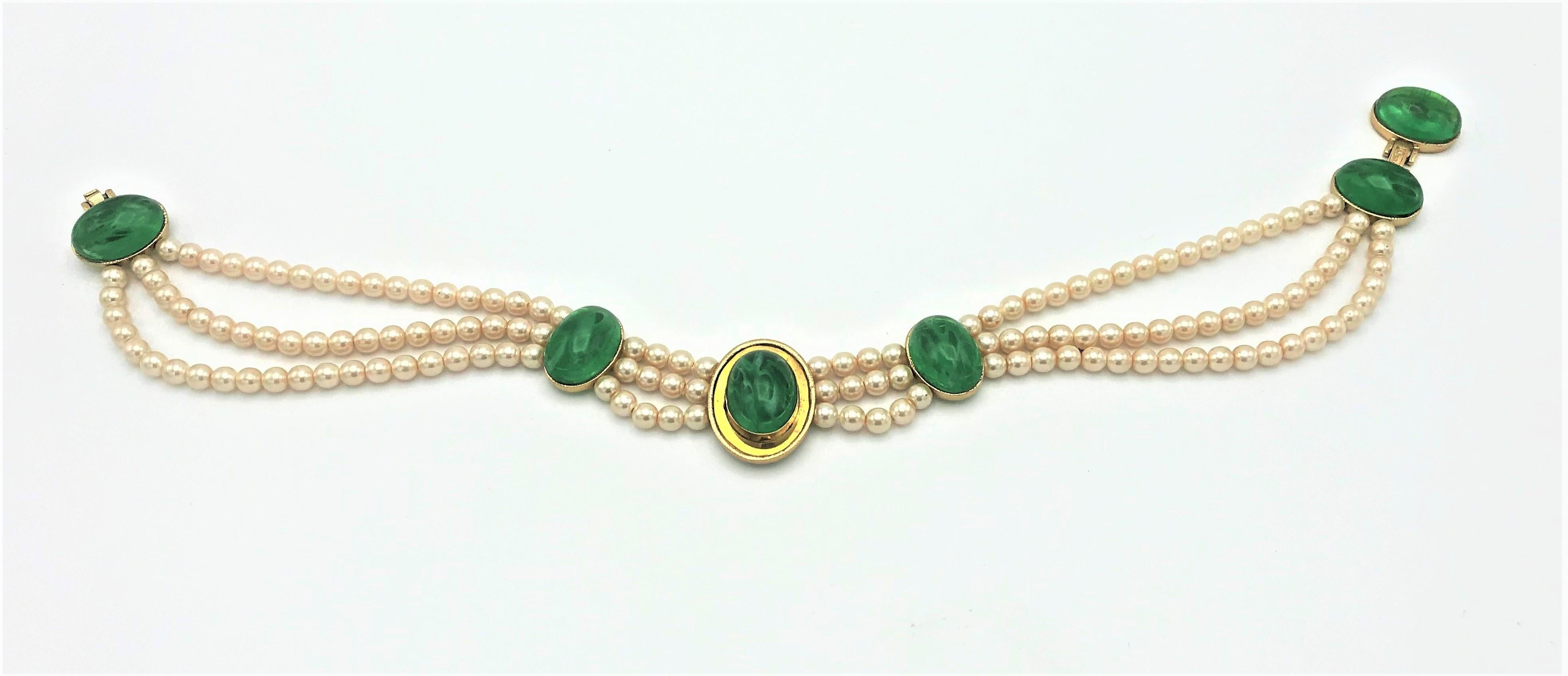 Elegant and rare Christian Dior necklace circa 1970s-1980s signed twice. 
Consisting of a triple row of fine Gripoix pearls (0,8 cm diameter) adorned with emerald cabochons (2,5 cm x 1,7 cm)
The green Gripoix glass is lightly marbleized for a rich