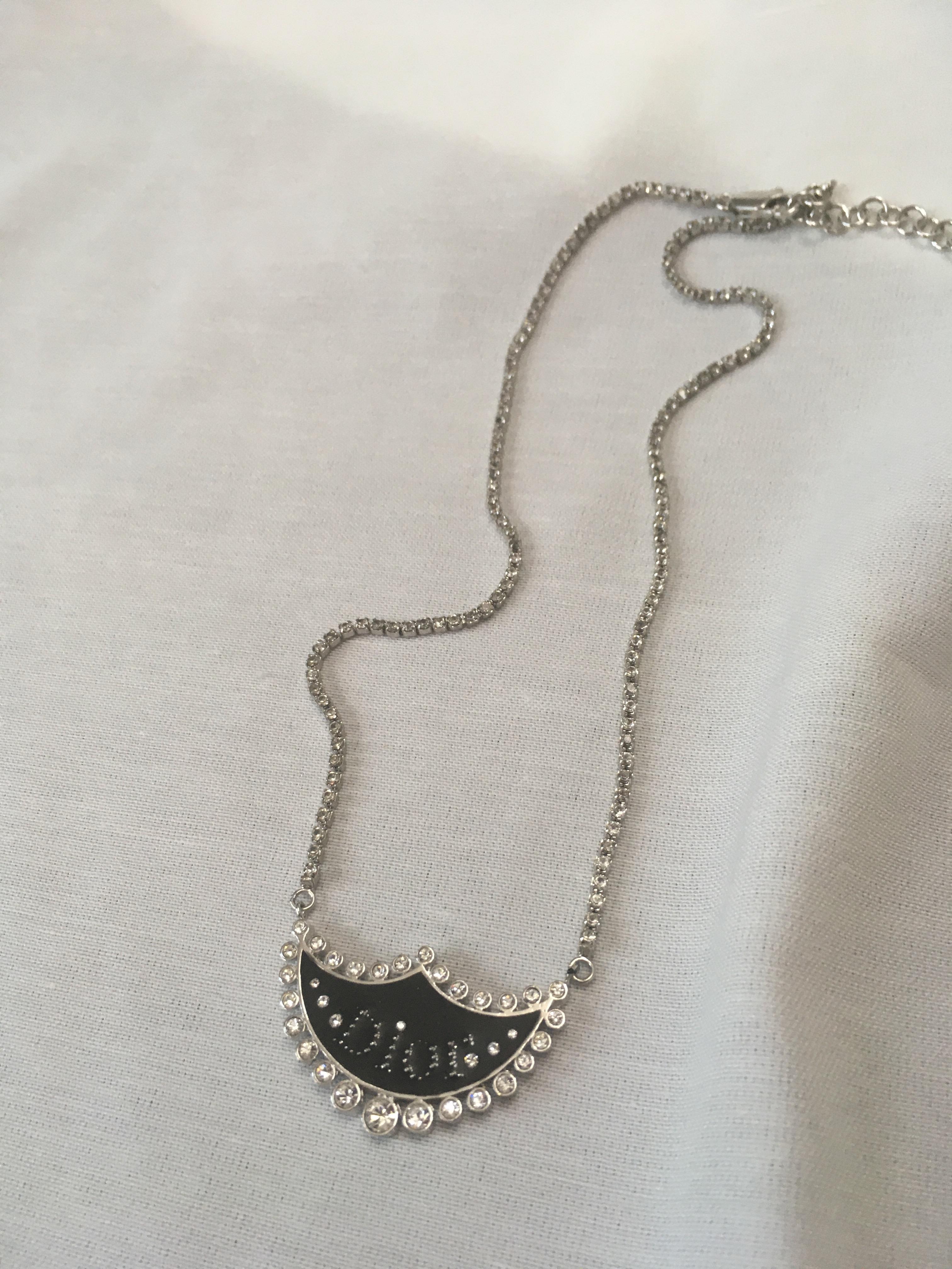 Vintage Christain Dior Necklace with clear rhinestones tennis link chain and black DIOR charm.



Indicative measurements: adjustable length from approx 40cm (15.748inches) to approx. 45cm (17.7165 inches).


Features:
- 100% Authentic CHRISTIAN