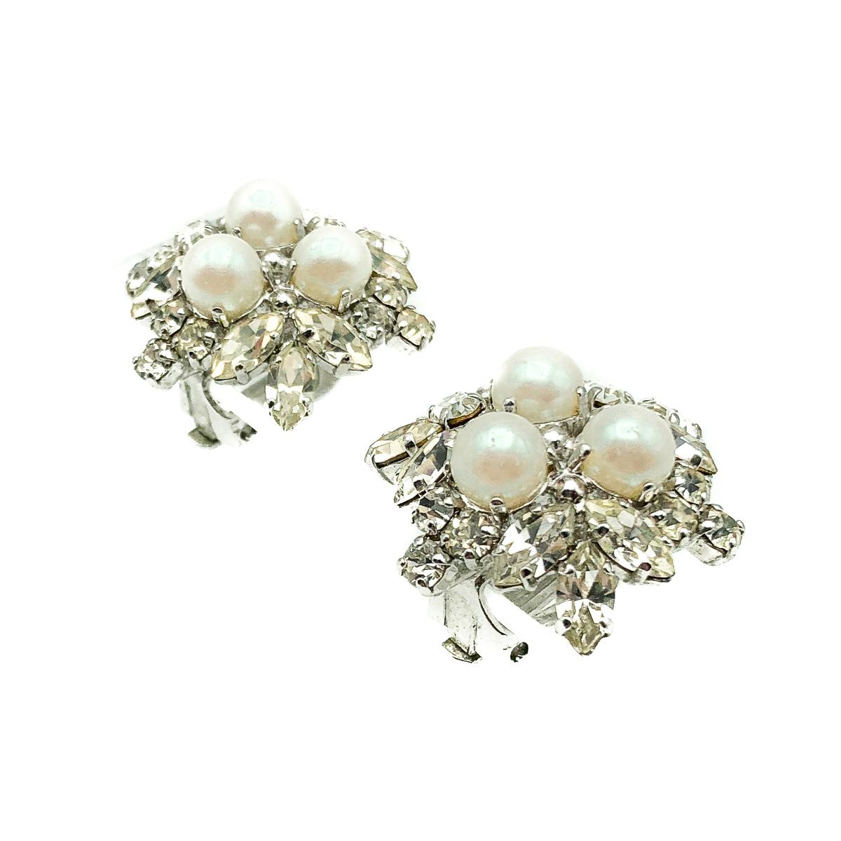 Seriously beautiful Vintage Dior Pearl Star Earrings from the House of Dior during the tenure of Marc Bohan in 1966 . Featuring a glorious arrage of fancy cut crystal stones surround a trio of simulated whole pearls in rhodium plated metal. All
