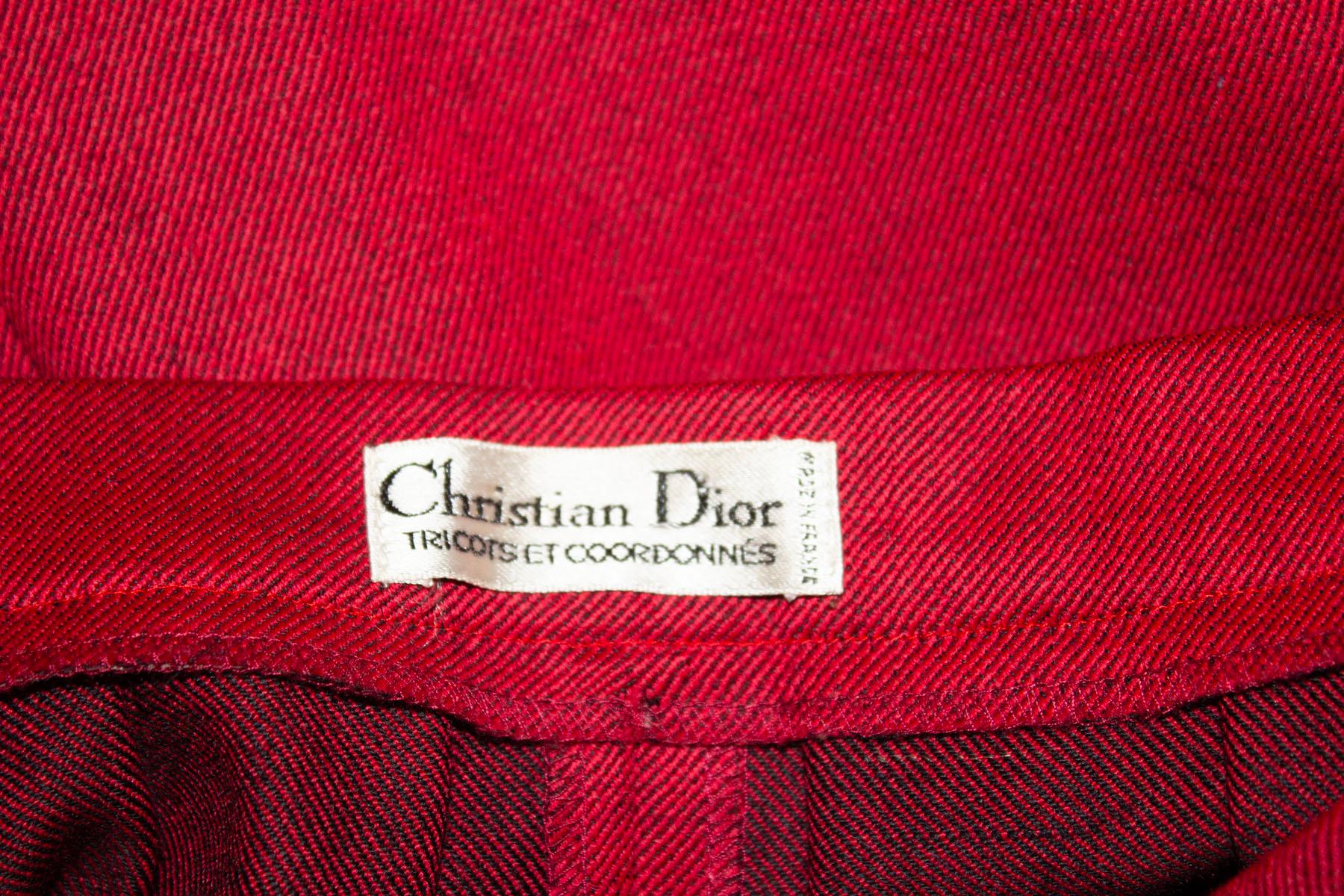 A chic and easy to wear vintage wool skirt by Christian Dior . The skirt is in a wonderful red wool with black weave. It has gathering at the waist, has  button through front and is unlined. There is a pocket on each side.
Measurements: Waist 26'',