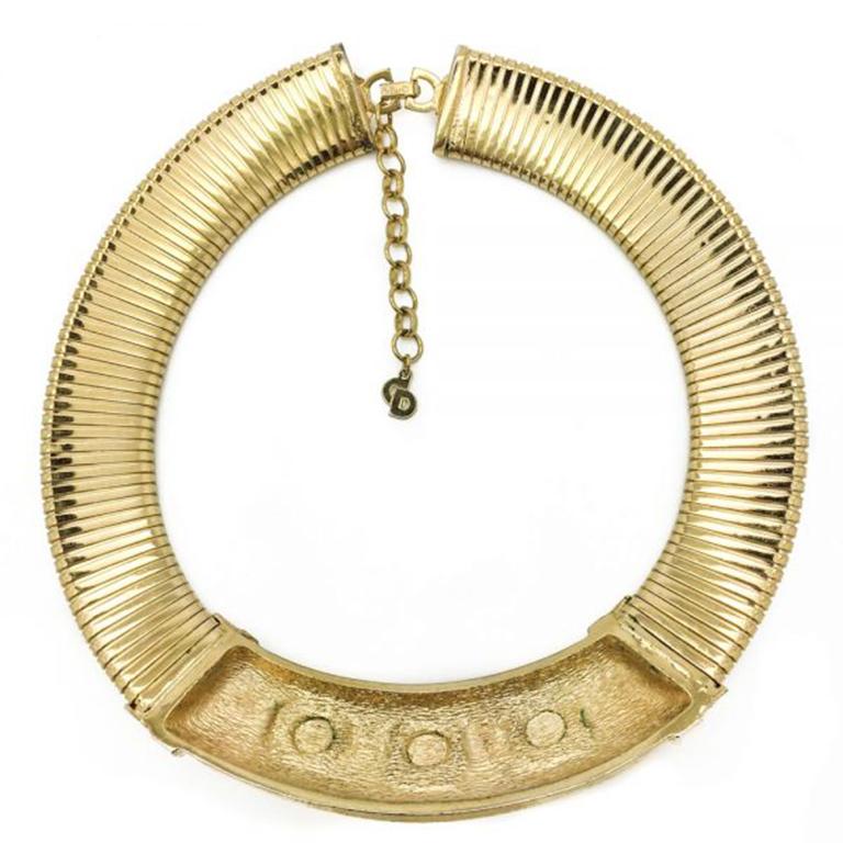 A simple yet wonderfully chunky and dramatic gold tone Vintage Dior Collar Necklace. This striking Christian Dior collar dates to the 1990s and is heavily gold plated with three delightful oval cabochon glass faux rubies set amongst clear crystal
