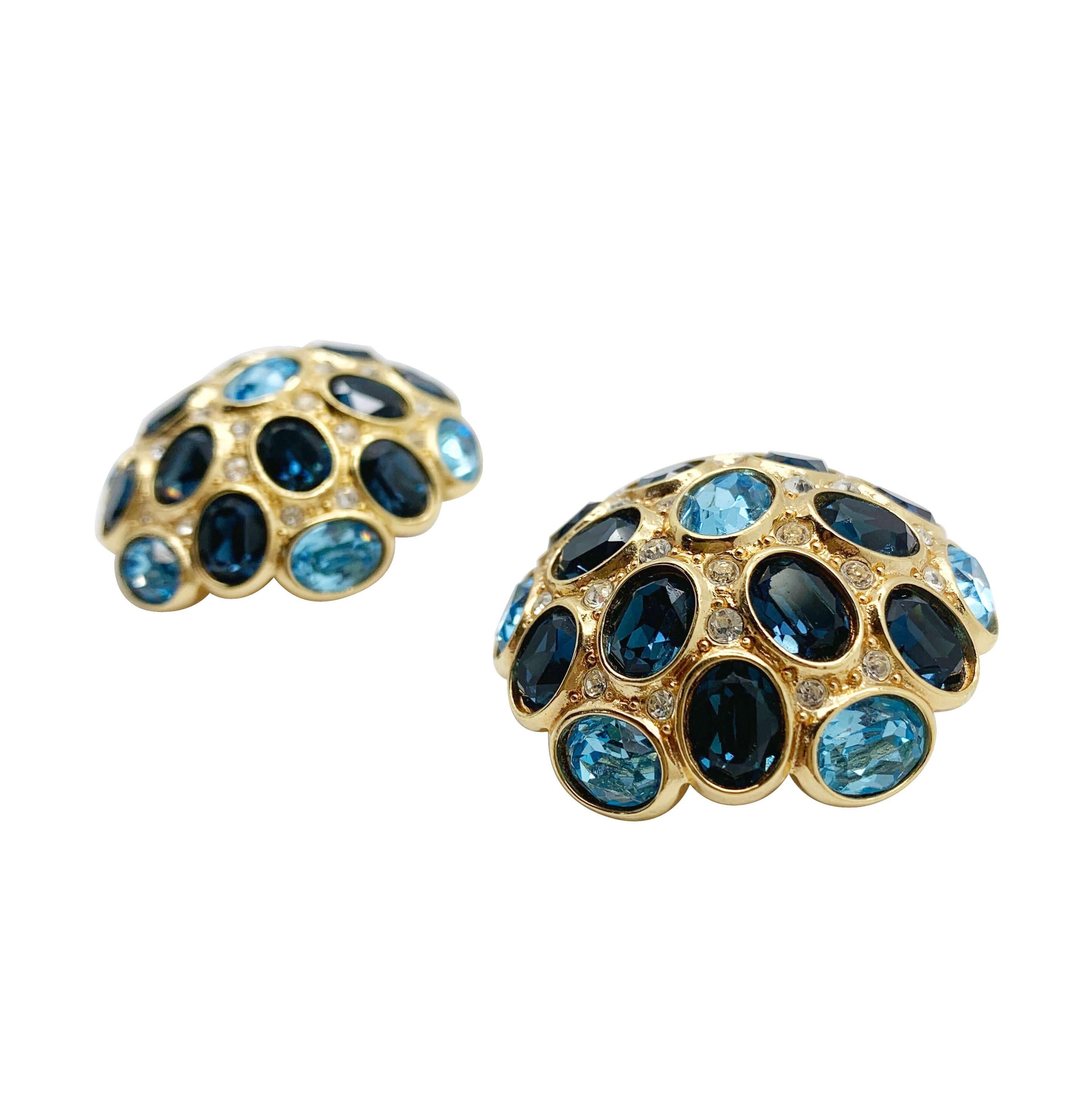 Our Vintage Dior Sapphire Earrings. Oversize domed crystal statement earrings from the House of Dior. The design, bold yet feminine. Wall to wall fancy cut crystals in shades of sapphire and blue topaz prove utterly captivating.  
With archive