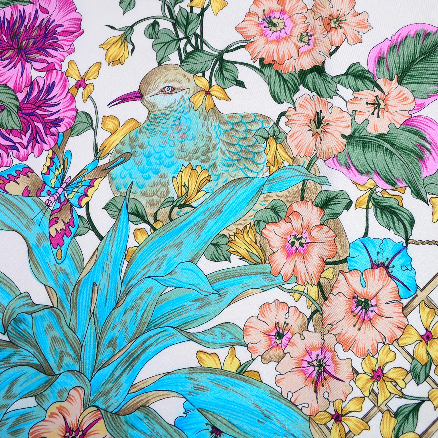 This is a pretty vintage Christian Dior scarf in a gorgeous pink, blue and yellow botanical silk bird print on white with a tan border. Made in Italy. 34