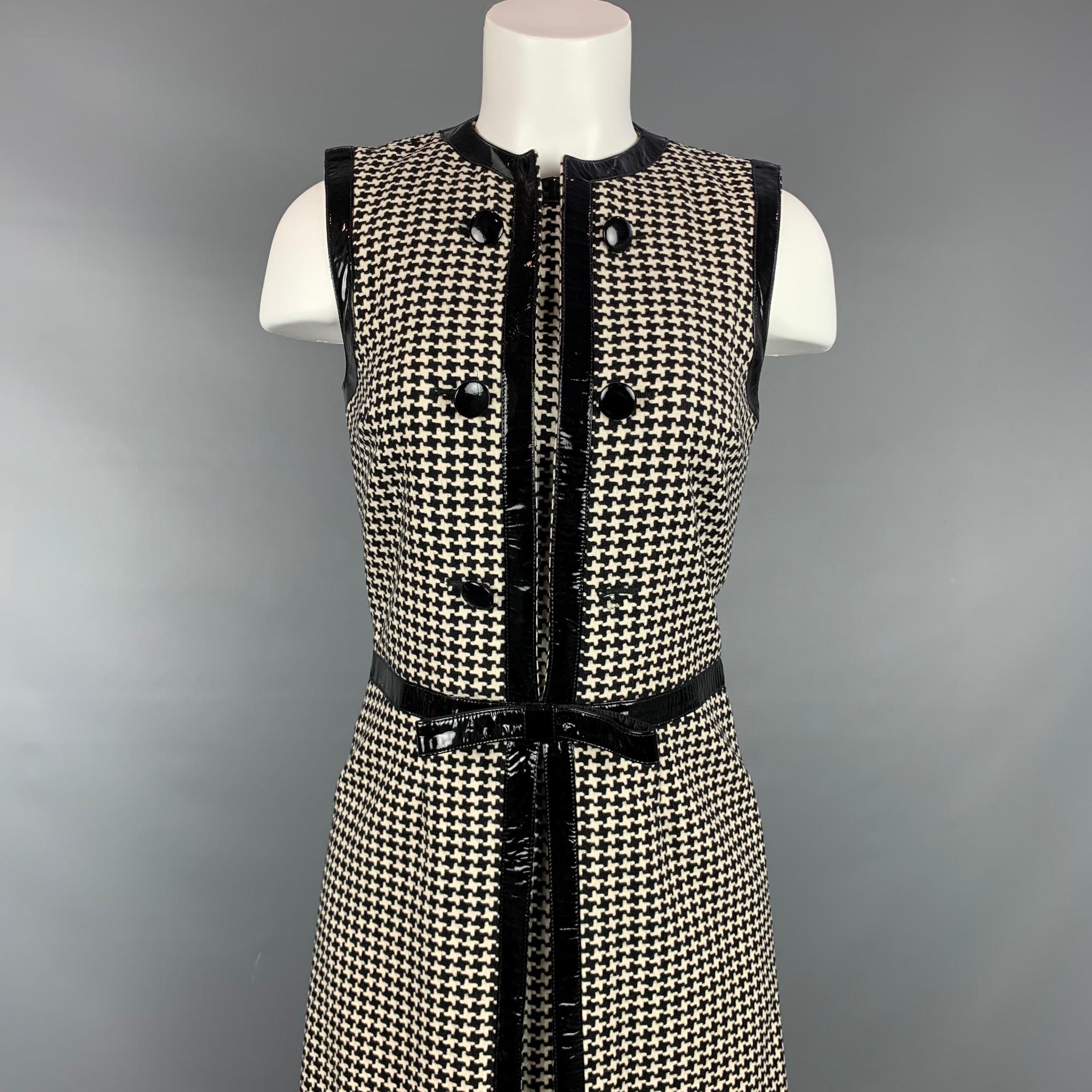 Vintage CHRISTIAN DIOR cocktail dress comes in a black & cream houndstooth wool / polyester with a slip liner featuring a bow detail, patent leather trim, collarless, front buttons, and a back zipper closure. Made in Italy.

Good Pre-Owned