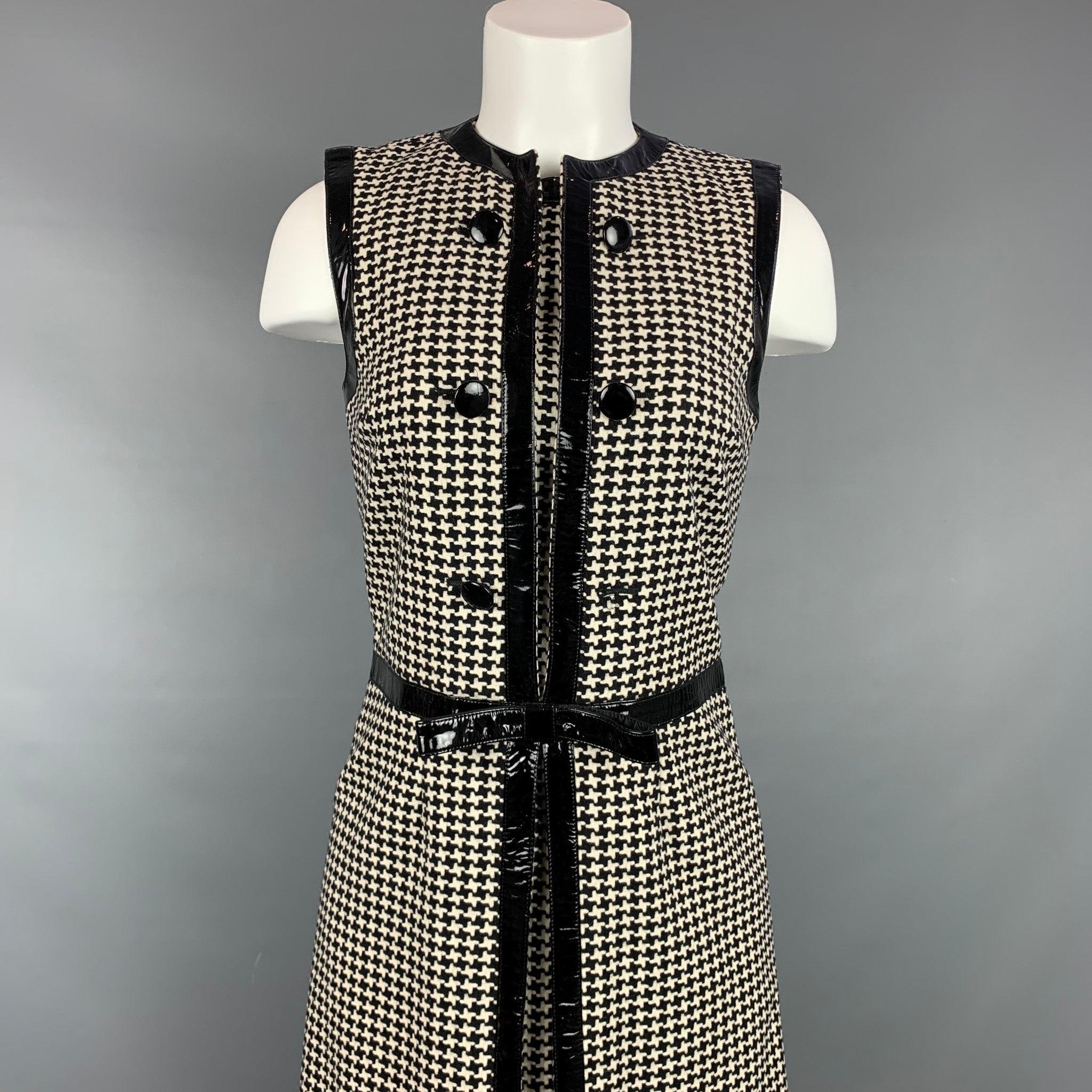 Vintage CHRISTIAN DIOR cocktail dress comes in a black & cream houndstooth wool / polyester with a slip liner featuring a bow detail, patent leather trim, collarless, front buttons, and a back zipper closure. Made in Italy.Good
Pre-Owned Condition.