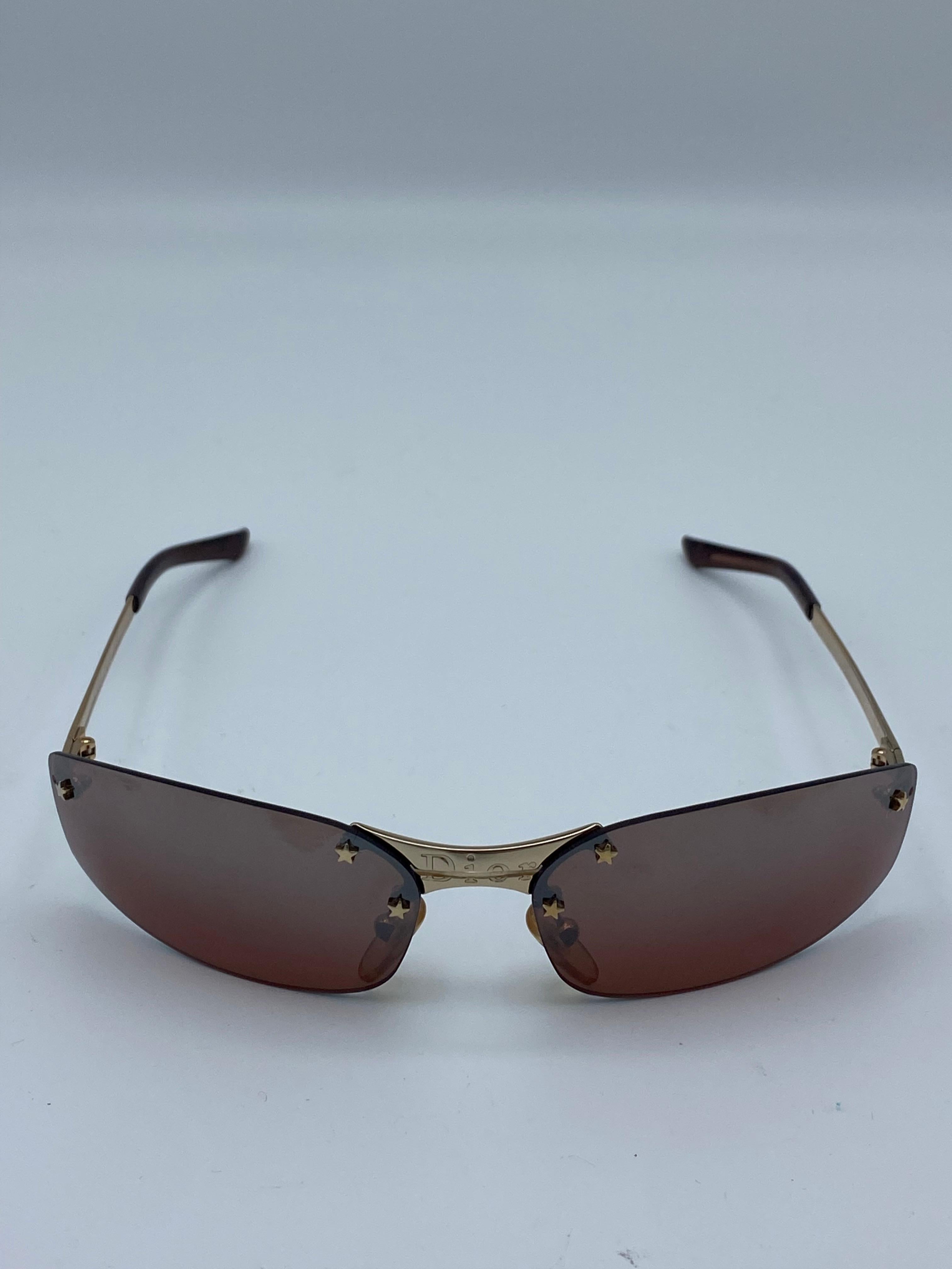 Product details:

The sunglasses feature brown frames with gold tone hardware and star motif.