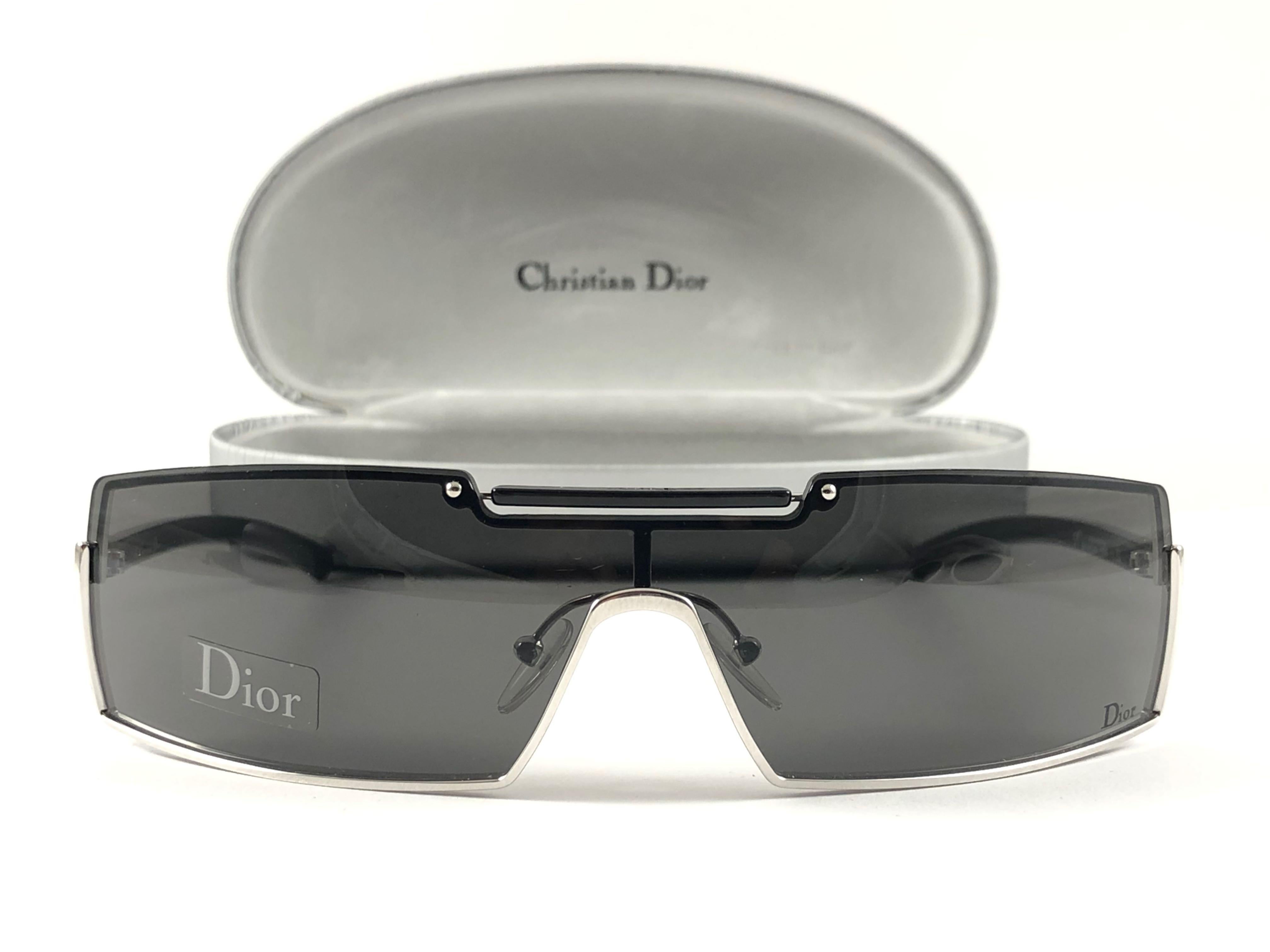  Vintage Christian Dior wrap around frame sporting medium grey lenses. 

Made in Austria.
 
This piece show minor sign of wear due to  storage.

Front : 15.5 cms

Lens Height : 3.5 cms

Lens Width : 15.5 cms 