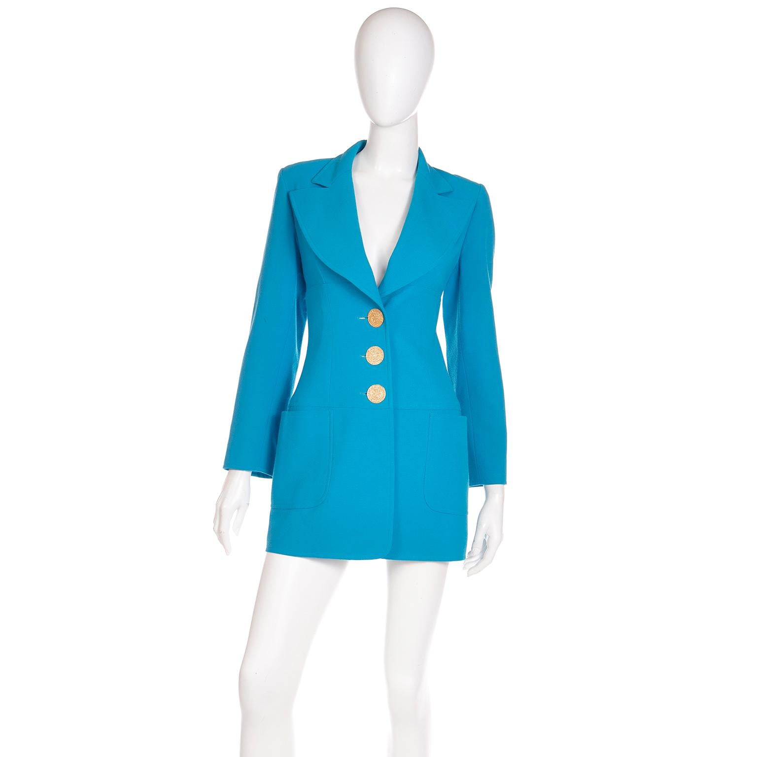 This is a Christian LaCroix vintage Spring Summer 1995 peacock blue long line blazer with embossed gold buttons This fine wool jacket has a flattering, fitted silhouette in a longline style. The gorgeous large 1 and 3/8