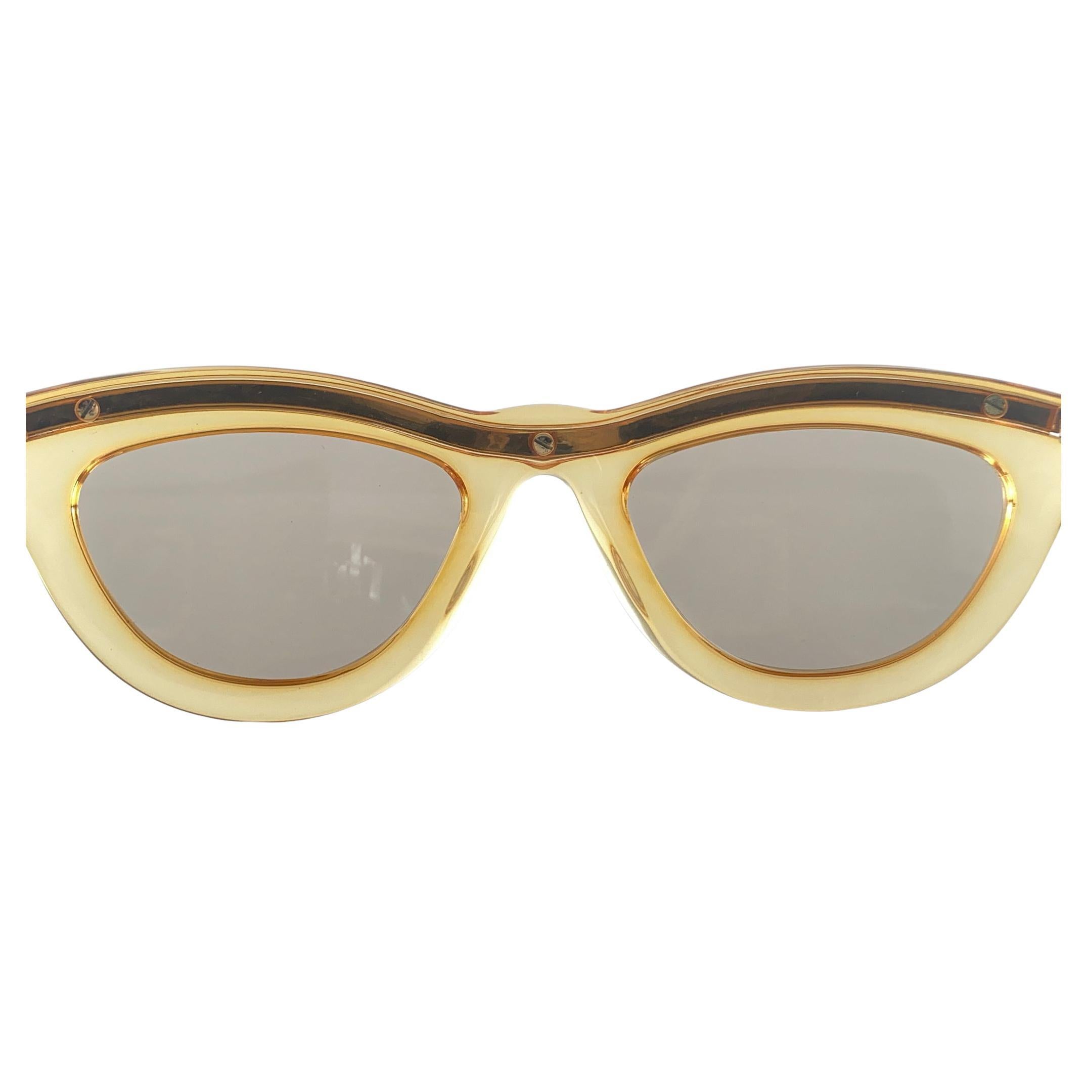 Vintage Christian Lacroix Cat Eye Sunglasses.   
Translucent Yellow & Gold Frame Holding A Pair Of Spotless Brown Gradient Lenses. 

New, Never Worn Or Displayed. 
This Item May Show Minor Sign Of Wear Due To Storage



Made In Austria


Front      