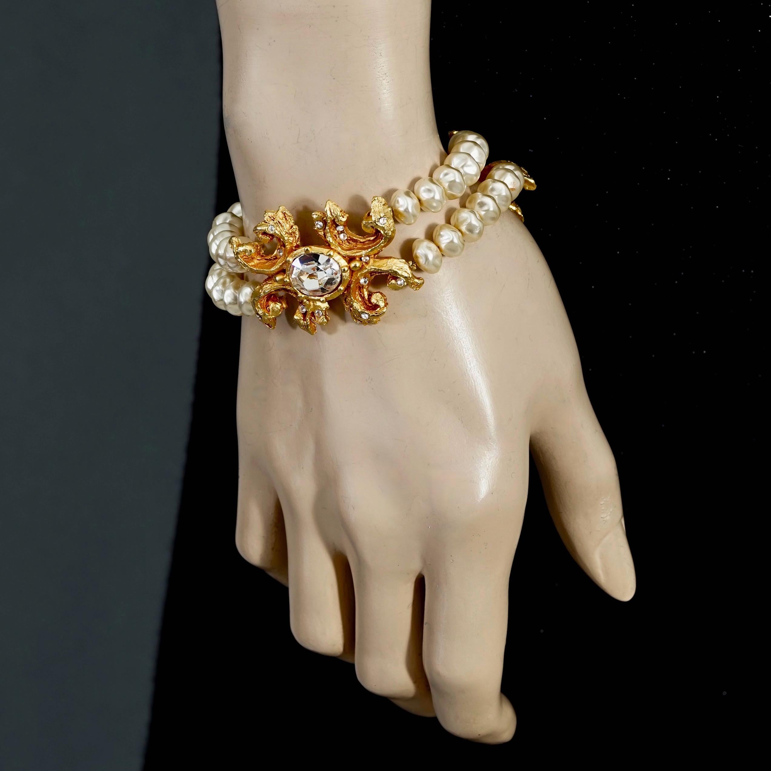 Vintage CHRISTIAN LACROIX Baroque Rhinestone 2 Layer Pearl Bracelet

Measurements:
Height: 1.25 inches (3.2 cm)
Wearable Length: 7.48 inches (19 cm) to 8.66 inches (22 cm)

Features:
- 100% Authentic CHRISTIAN LACROIX.
- Baroque style with