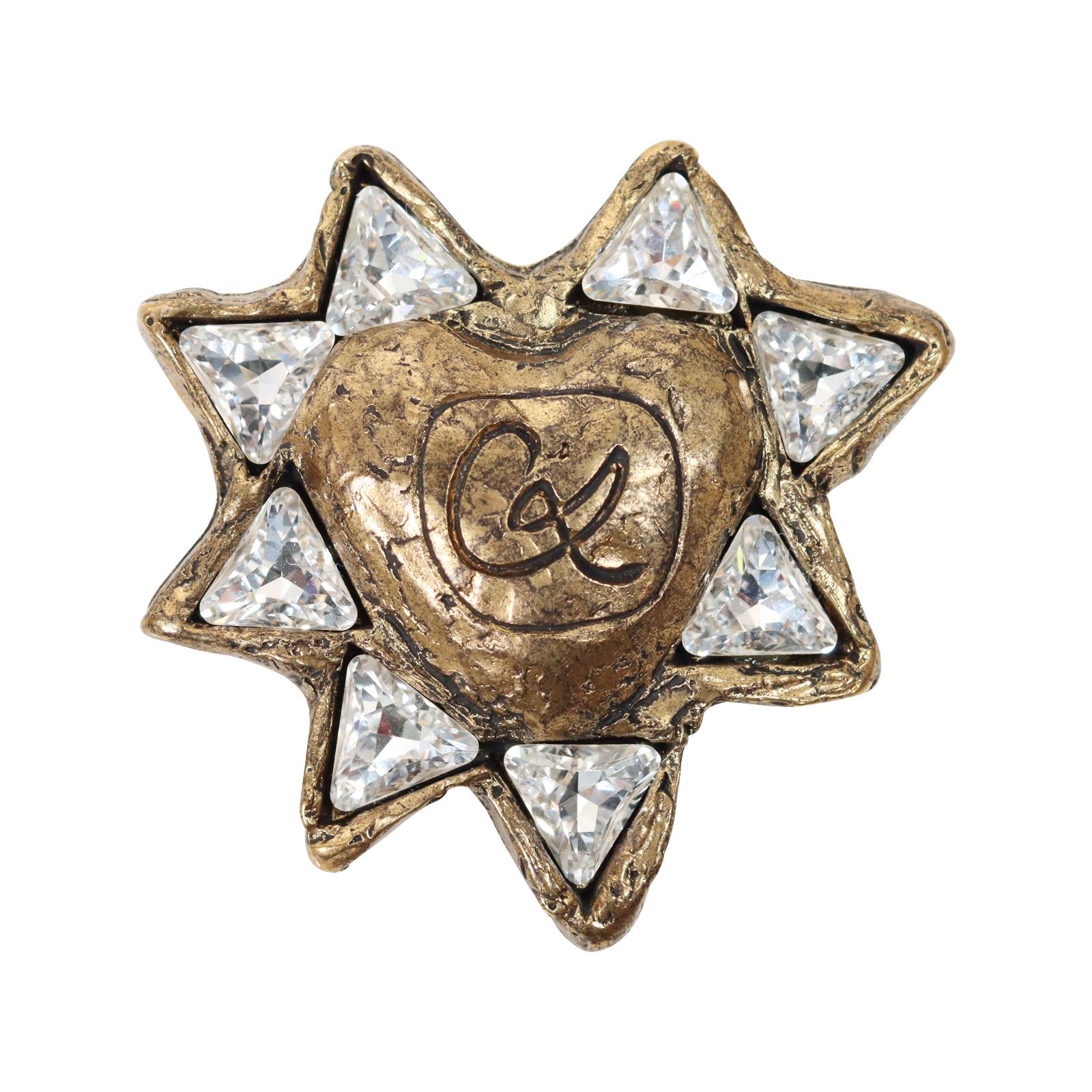 Vintage Christian Lacroix Bronze Tone Resin and Crystal Brooch. So Different than what I have seen. Looks Great on a White or Black Shirt.  Also looks amazing on a turtleneck!!  Off to the side. A very modern brooch!

Lacroix says his fashion icon