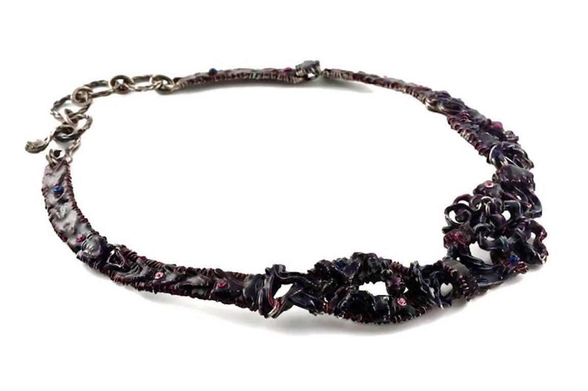 Vintage CHRISTIAN LACROIX Brutalist Enamel Rhinestones Choker Necklace

Measurements:
Height: 1 4/8 inches

Features:
- 100% Authentic CHRISTIAN LACROIX.
- Rigid choker in brutalist pattern with purple and violet enamel
- Embellished with