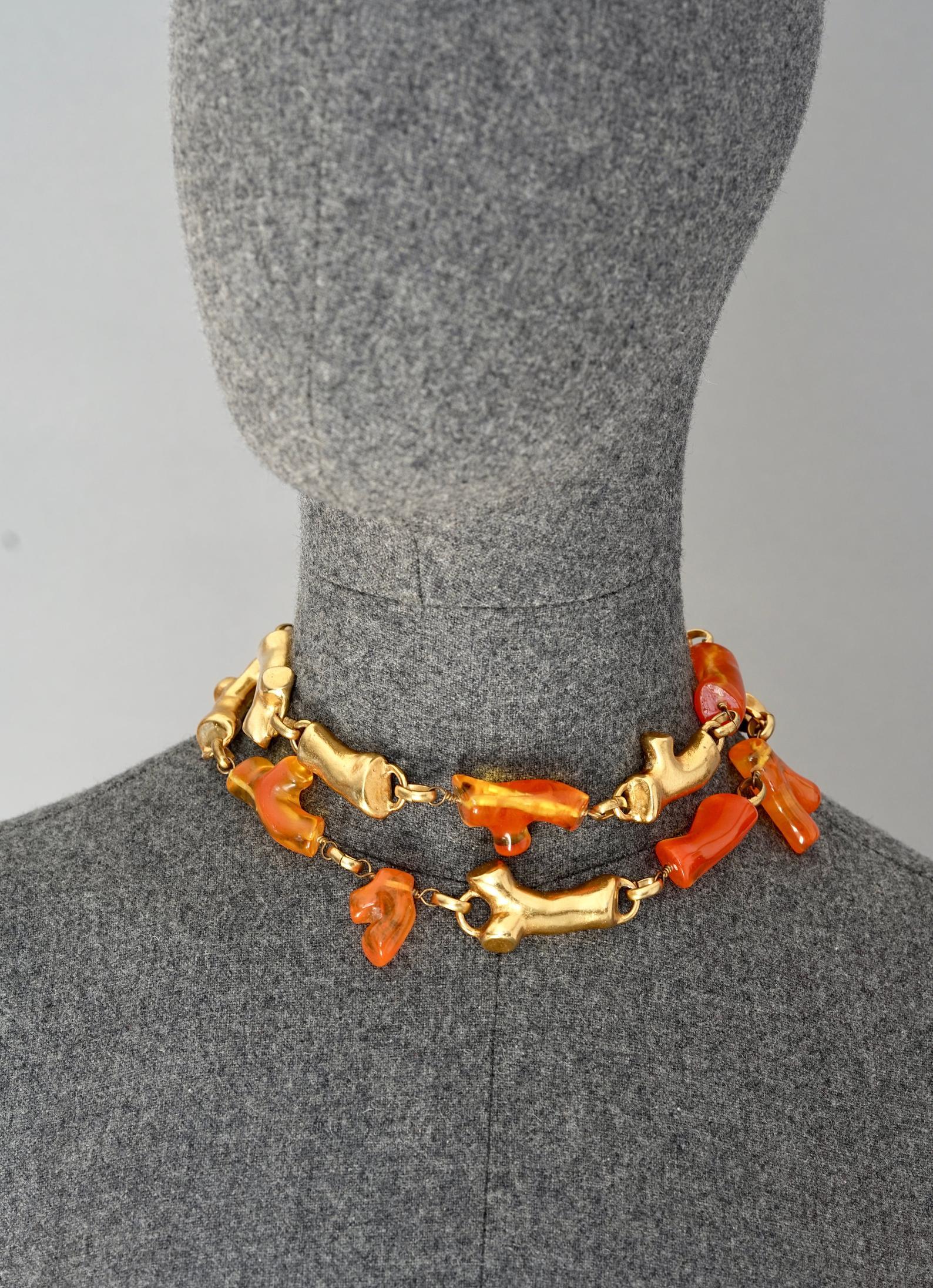 Vintage CHRISTIAN LACROIX Coral Lucite Multi Strand Necklace

Measurements:
Height: 2 inches (5 cm)
Wearable Length: 14.17 inches (36 cm)

Features:
- 100% Authentic CHRISTIAN LACROIX.
- Two tiered coral links in lucite orange and gold tone.
-
