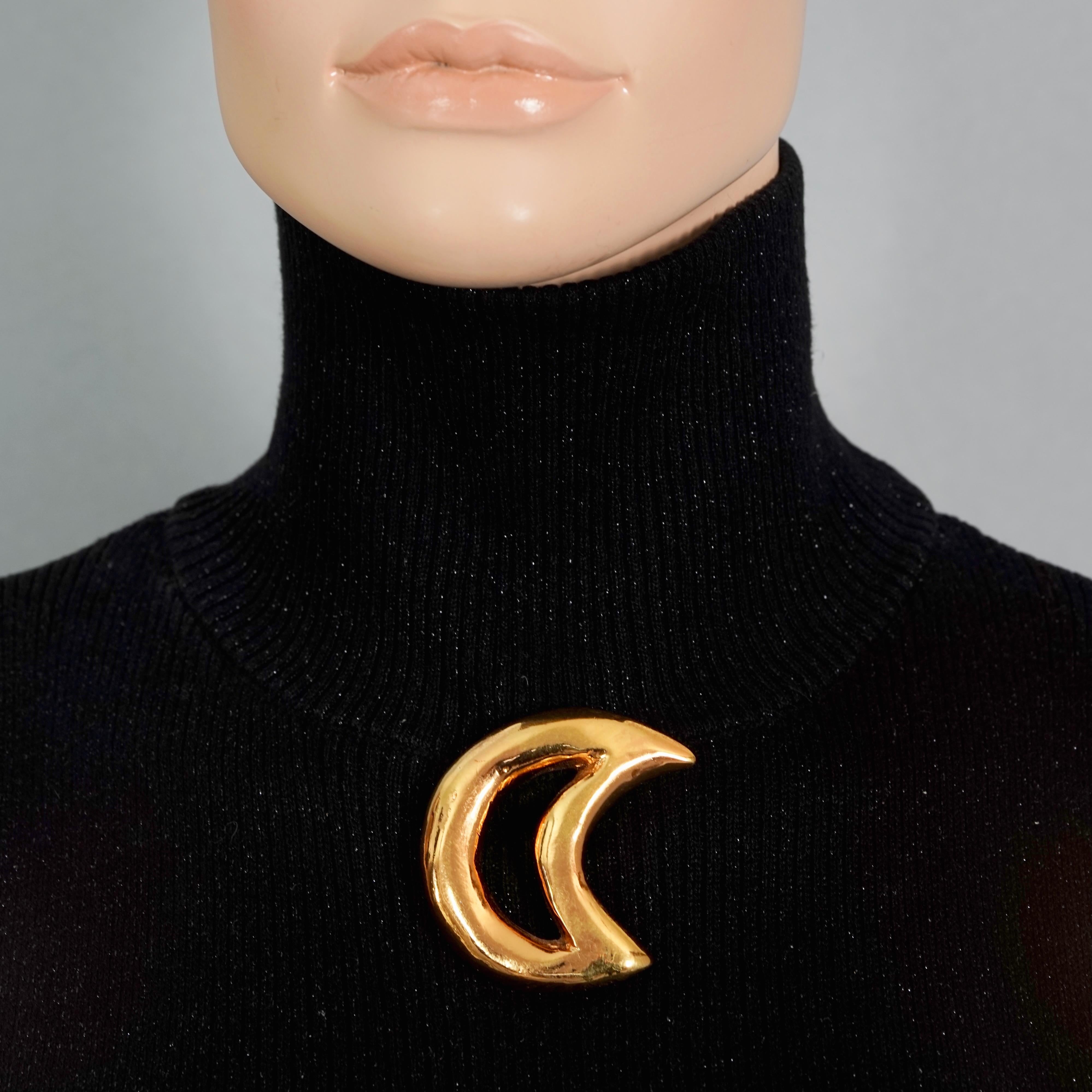 Vintage CHRISTIAN LACROIX Cutout Gold Moon Brooch

Measurements:
Height: 2.16 inches (5.5 cm)
Width: 2.16 inches (5.5 cm)

Features:
- 100% Authentic CHRISTIAN LACROIX.
- Cutout moon gilt resin brooch.
- Gold tone hardware.
- Signed Christian