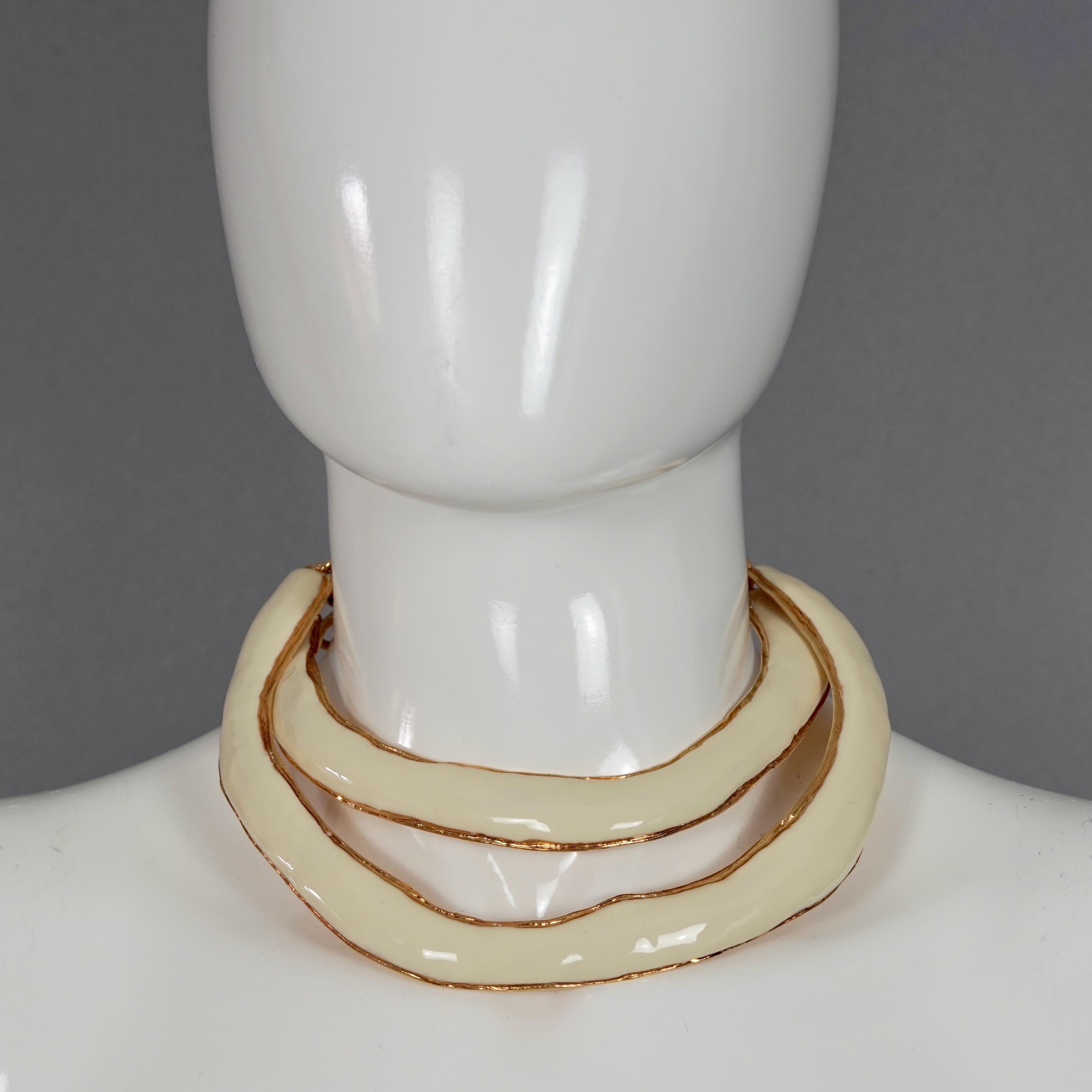 Vintage CHRISTIAN LACROIX Double Layer White Enamel Rigid Choker Masai Necklace

Measurements:
Inner Circumference: 12.40 inches (31.5 cm) 
Chain Extender: 4.92 inches (12.5 cm)
Centre Height Drop: 1.77 inches (4.5cm)

Features:
- 100% Authentic