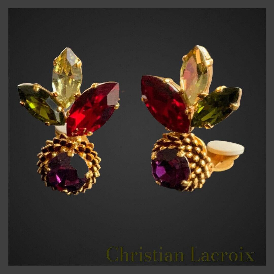 Very pretty and original earrings signed CHRISTIAN LACROIX. Clasp with clips, golden color, copper plated with 24 carats gold set with SWAROVSKI. Dominant stone in crystal, of different colors.
