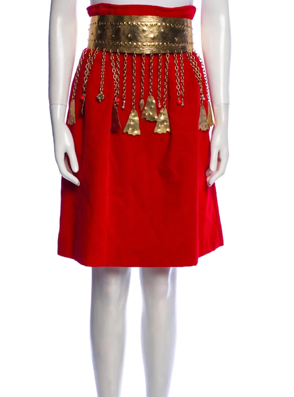 Rare two-piece skirt set from Haute Couture collection by Christian Lacroix. Jacket and skirt are lavishly decorated with studs and crystal accents. Metal belt with dangling tassels. 
Button closure. 
Collection 1988. 
Size: S. 
Size is not listed,