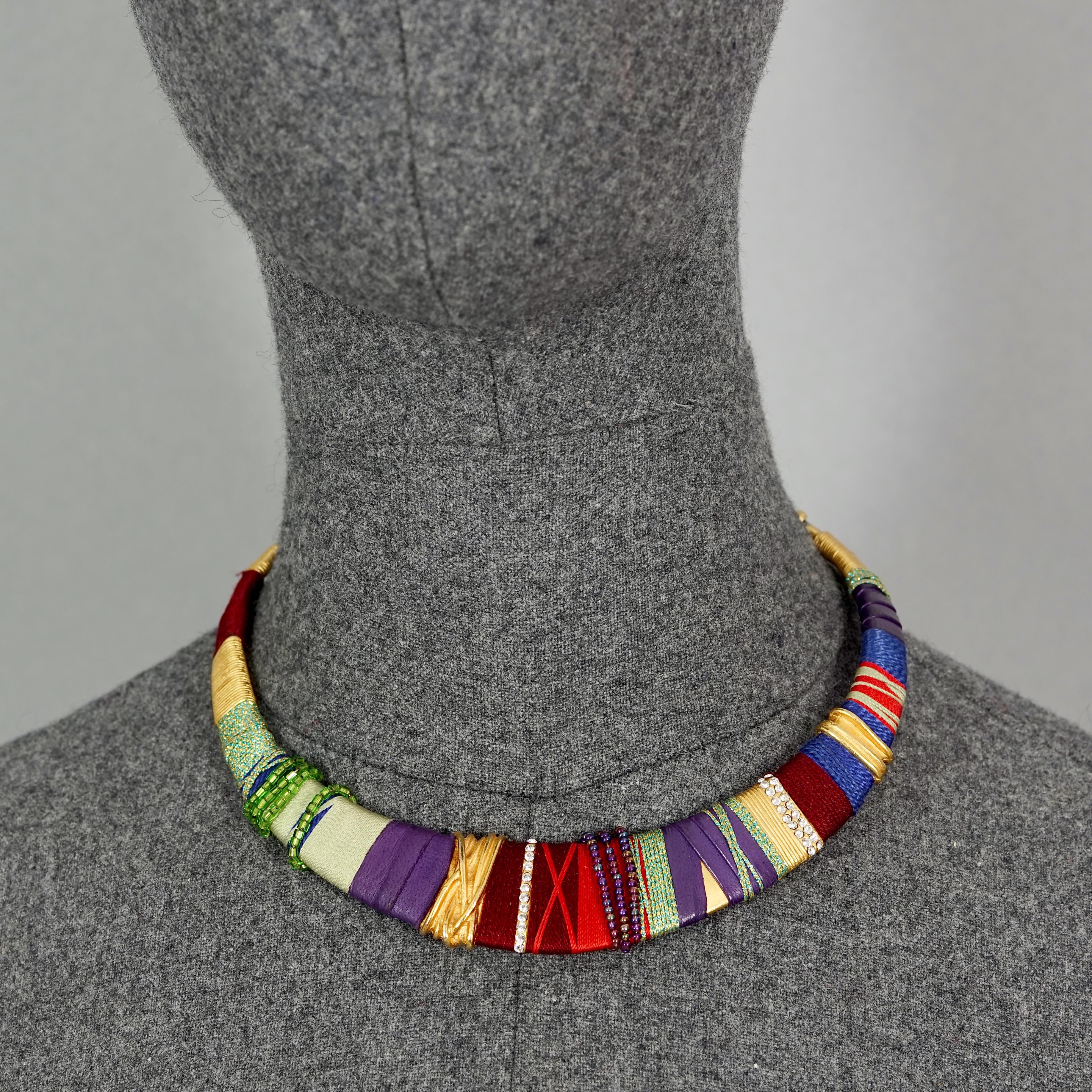 Vintage CHRISTIAN LACROIX Ethnic Masai Rigid Choker Necklace

Measurements:
Height: 0.94 inch (2.4 cm)
Wearable Length: 14.96 inches (38 cm)

Features:
- 100% Authentic CHRISTIAN LACROIX.
- Colourful ethnic Masai choker necklace with wrapped thread,