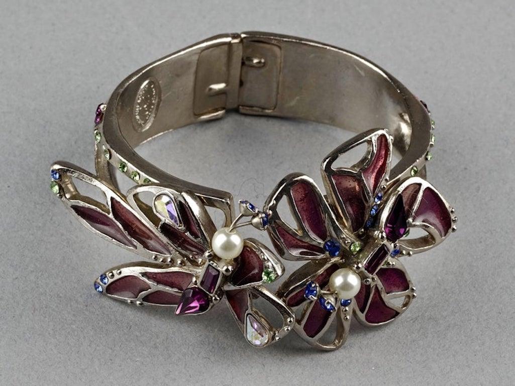 Vintage CHRISTIAN LACROIX Flower Stained Glass Silver Cuff Bracelet

Measurements:
Height: 1.53 inches (3.9 cm)
Inner Circumference: 6.30 inches (16 cm)

Features:
- 100% Authentic CHRISTIAN LACROIX.
- Cuff bracelet adorned with flower stained