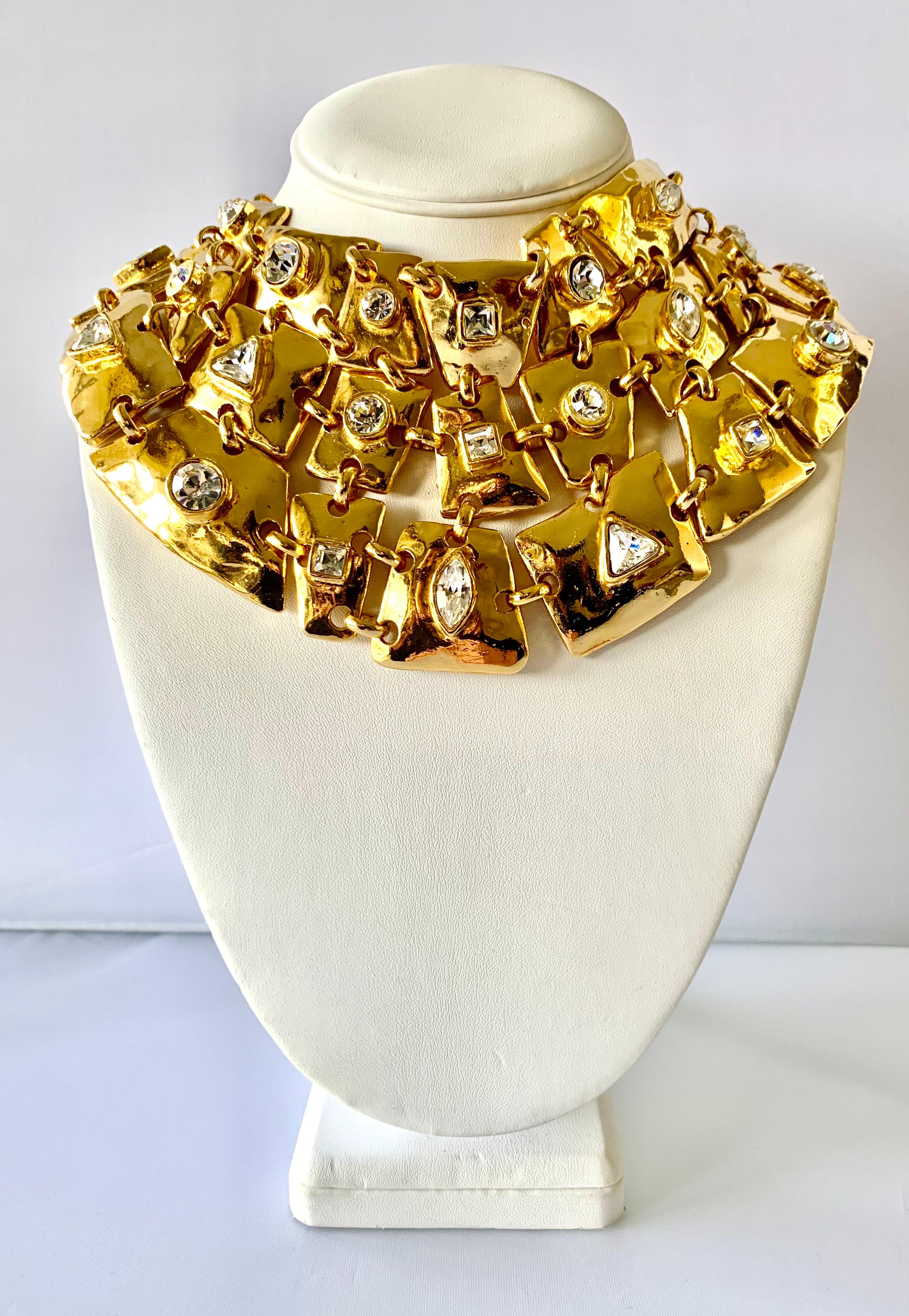 Vintage runway Christian Lacroix necklace comprised out of articulated gilt metal segment adorned with large faceted diamante rhinestones in the center. The articulated plates allow the necklace to sit perfectly on the neck and chest. Signed