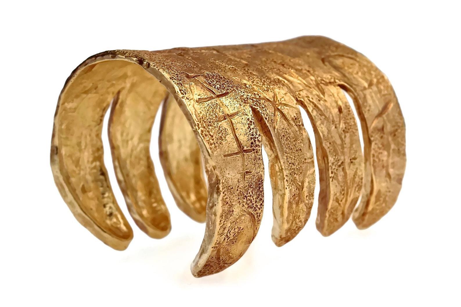 Vintage CHRISTIAN LACROIX Graffiti Claw Wide Cuff Bracelet

Measurements:
Height: 3/14 inches (8 cm)
Inner Circumference: 6.69 inches (17 cm)

Features:
- 100% Authentic CHRISTIAN LACROIX.
- Gilt textured wide cuff in gold tone.
- Wide gilt cuff