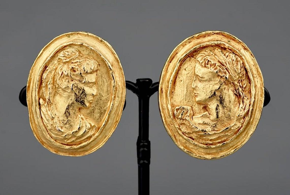 Vintage CHRISTIAN LACROIX Greek Roman Cameo Earrings

Measurements:
Height: 1.69 inches (4.3 cm)
Width: 1.38 inches (3.5 cm)

Features:
- 100% Authentic CHRISTIAN LACROIX.
- Raised cameo of Roman Greek god/ goddess.
- Gold tone.
- Signed CHRISTIAN