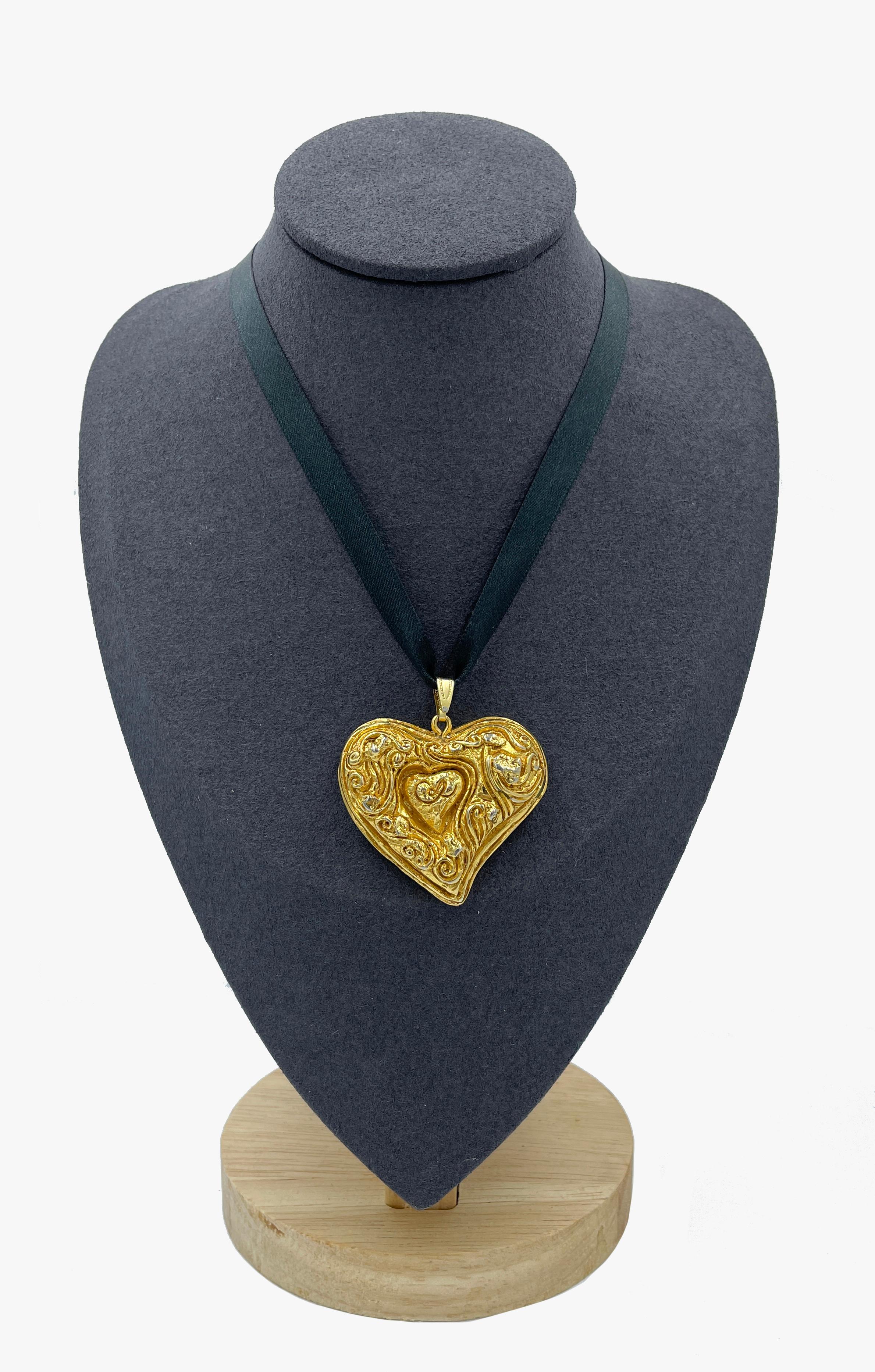 A chic chunky heart pendant by Christian Lacroix. 
A vintage piece with signature CL in the centre of the heart. 
The heart measures 4.7cm wide by 4.2cm high

(!) Black choker necklace not included – pendant only. 

Good vintage condition, the stamp